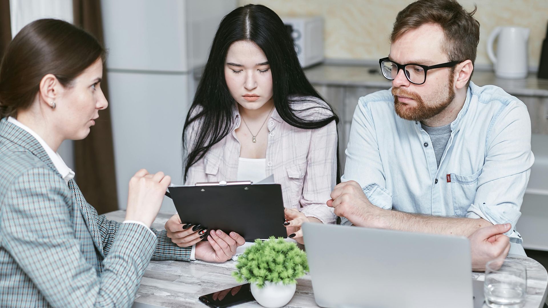 A group of professionals discussing business strategies at a table indoors.