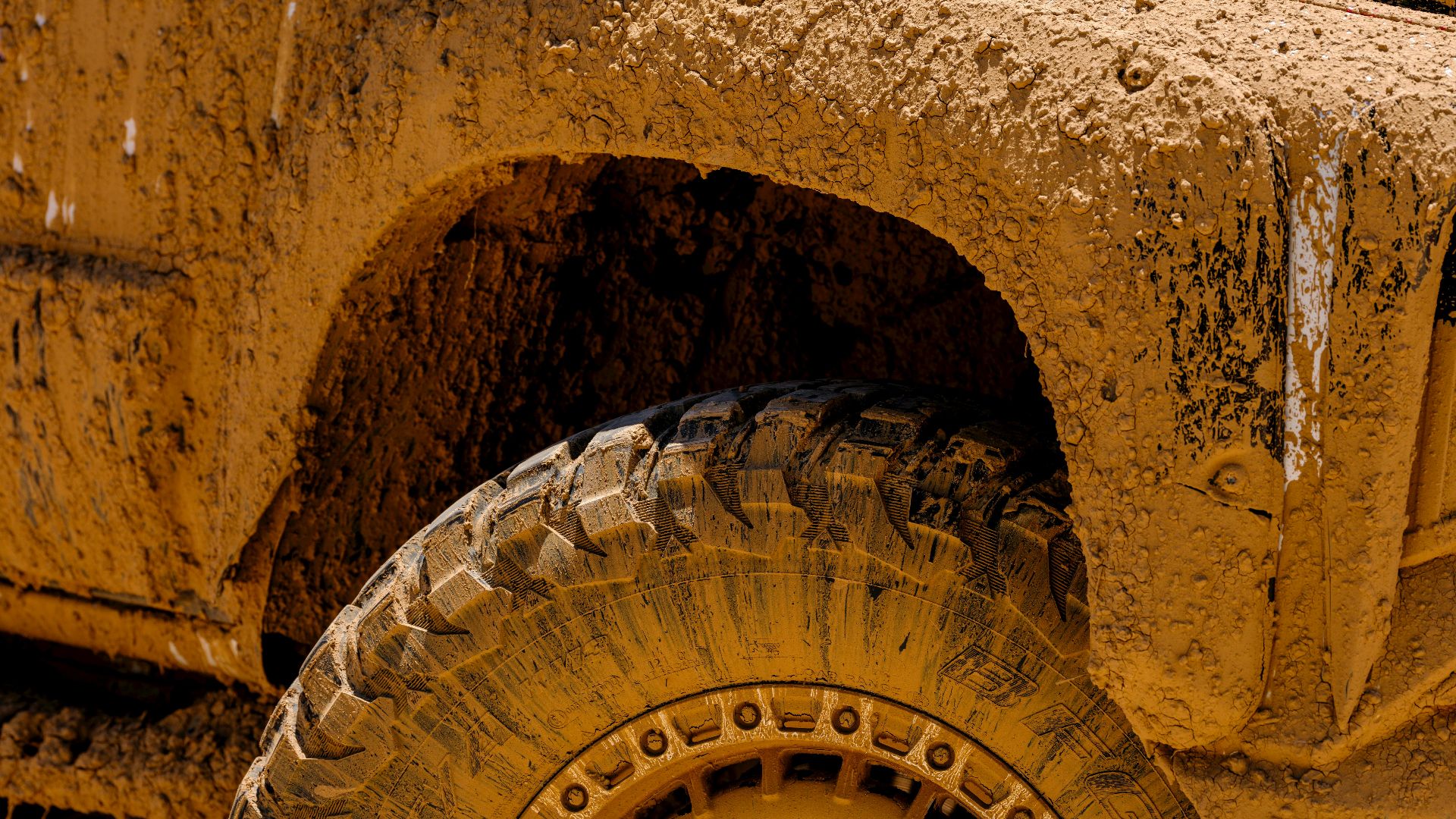 Close-up of a muddy 4x4 vehicle highlighting off-road adventure and rugged driving.