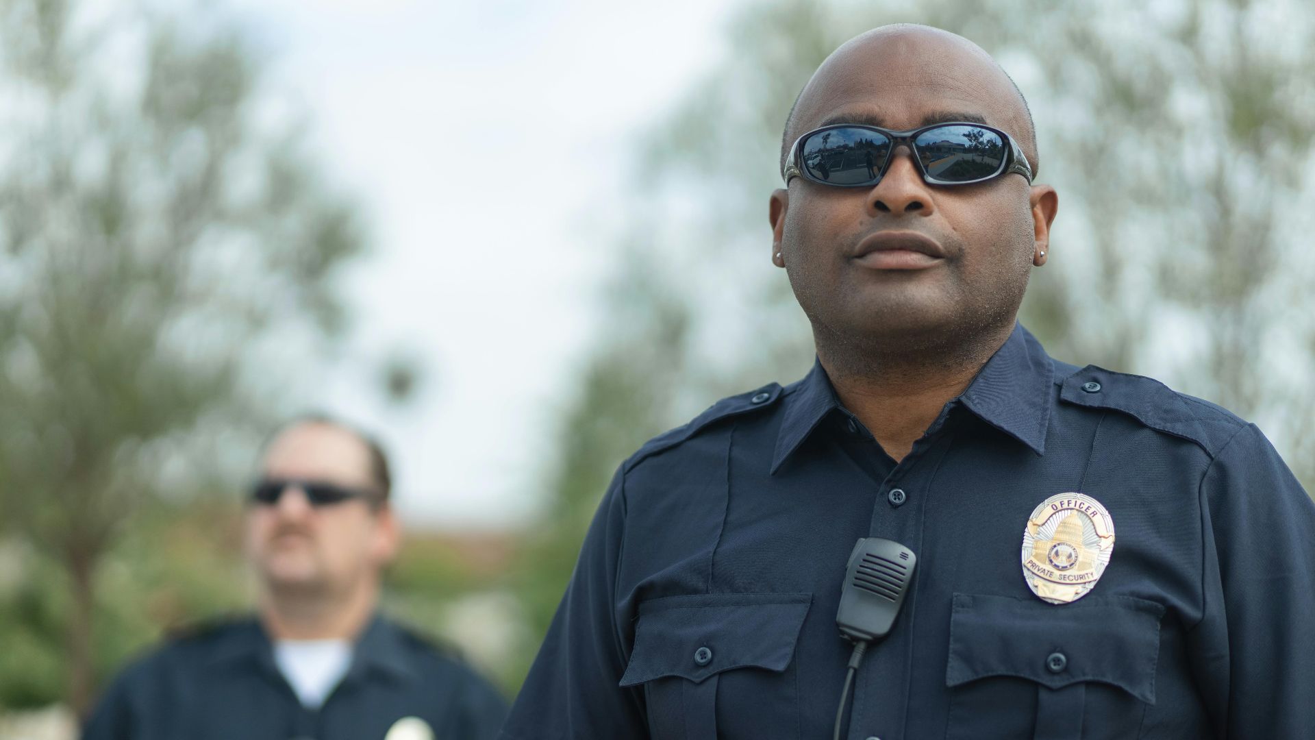 Police officers standing outdoors ensuring public safety. Law enforcement teamwork and professionalism.
