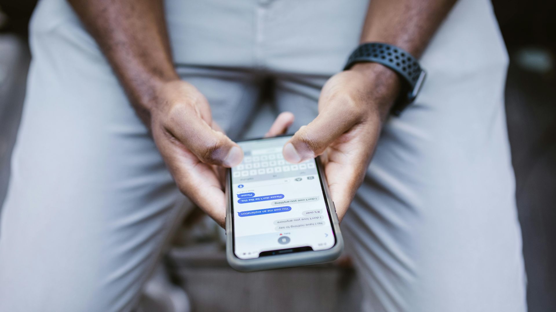 Close-up view of a man texting on a smartphone, capturing communication in action.