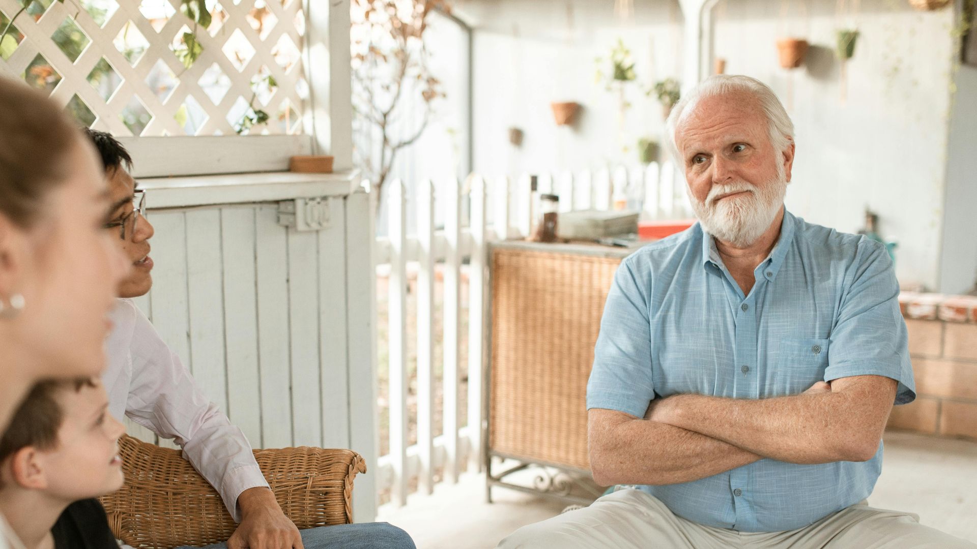 Family gathered indoors, engaged in conversation with a focus on bonds and togetherness.