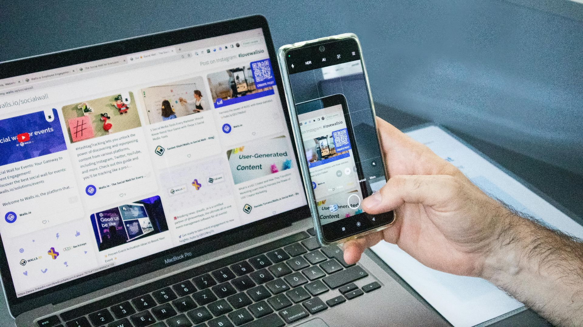 Close-up of a smartphone capturing a laptop screen, representing technology integration.