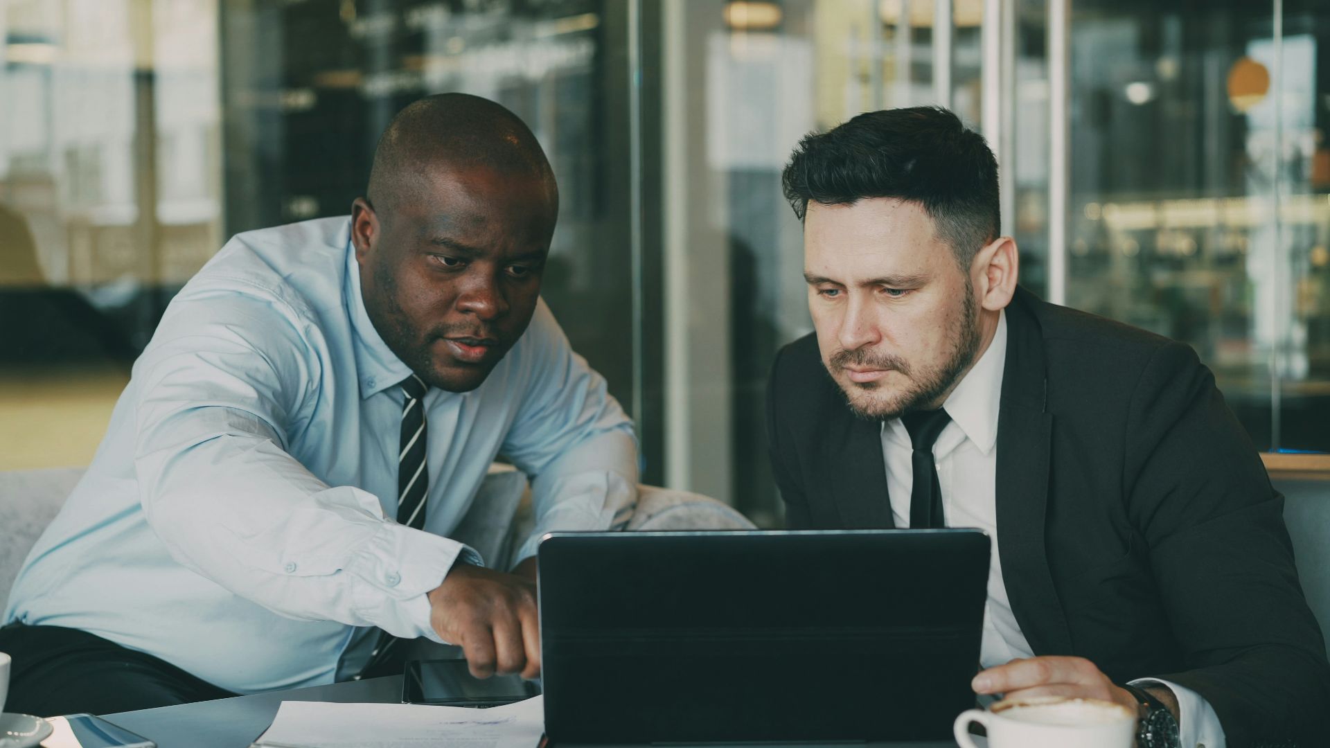 Two men looking at a laptop together