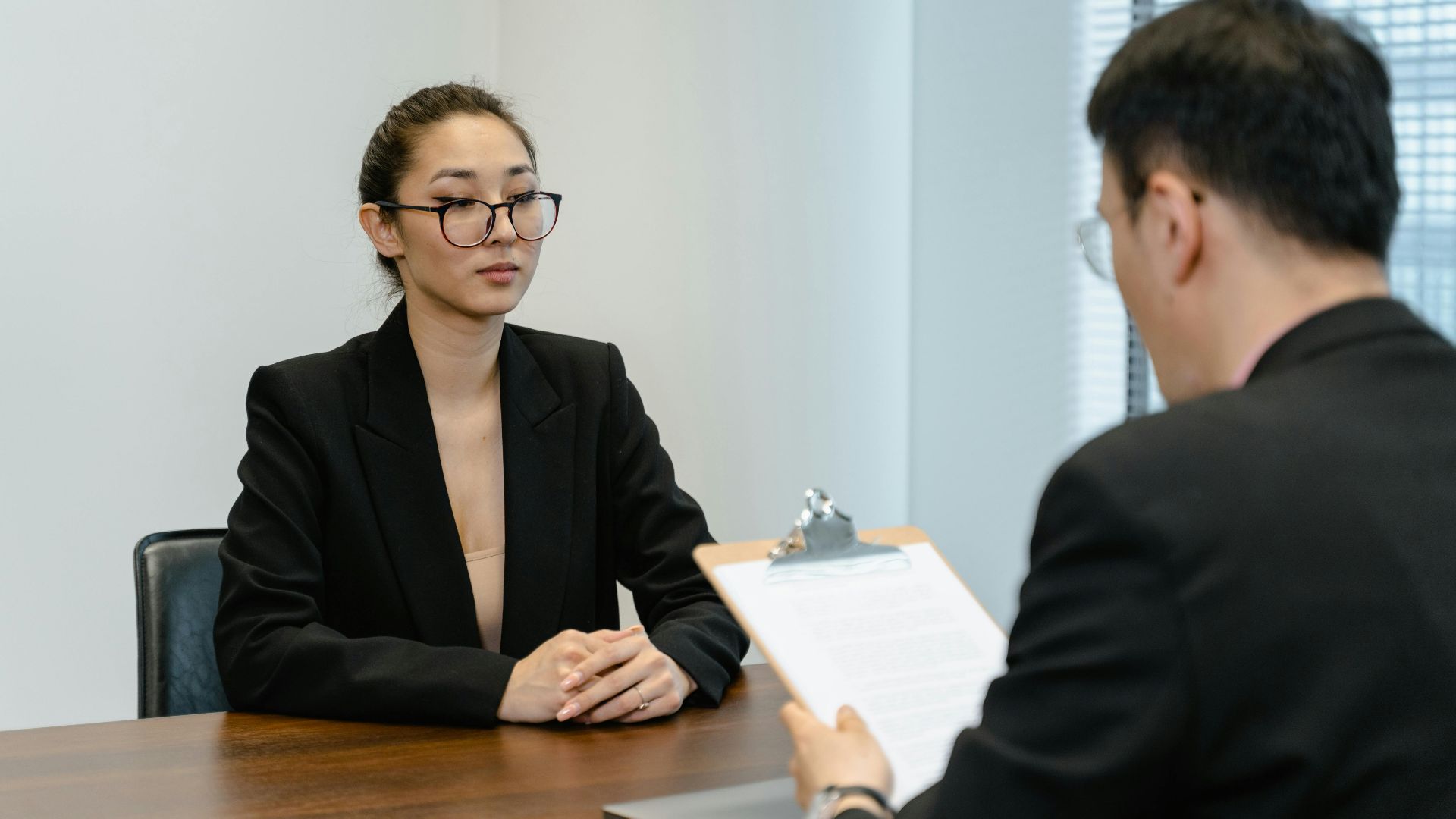 Business interview scene with professionals in office setting.