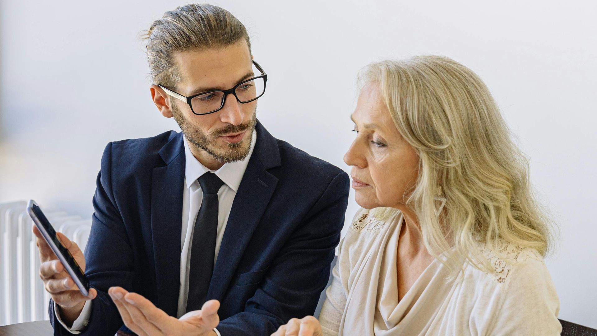 Professional business discussion between a consultant and client in an office setting.