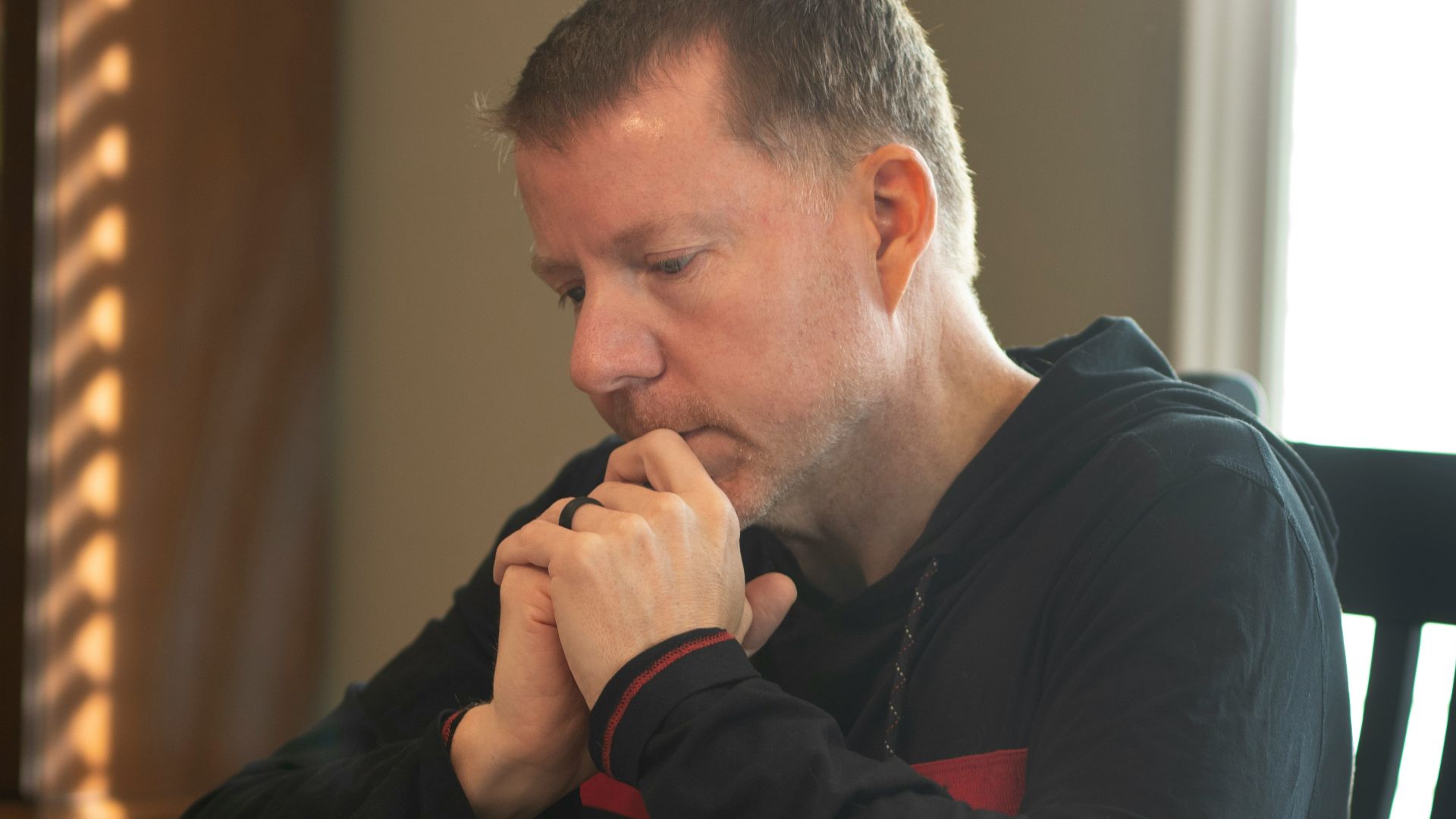 a man sitting at a table with a book in front of him