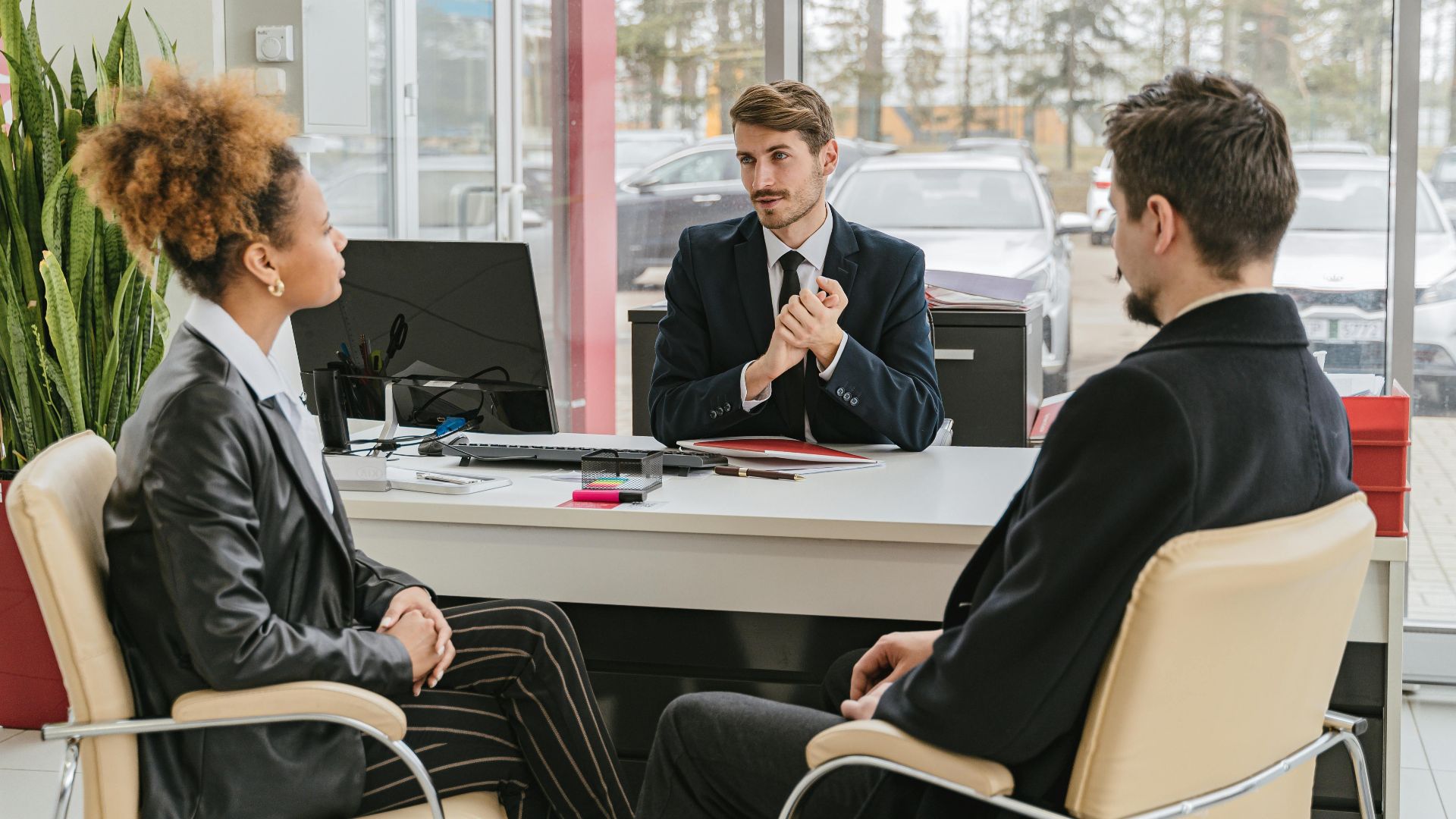 Professional meeting with clients at a modern office, discussing business solutions.
