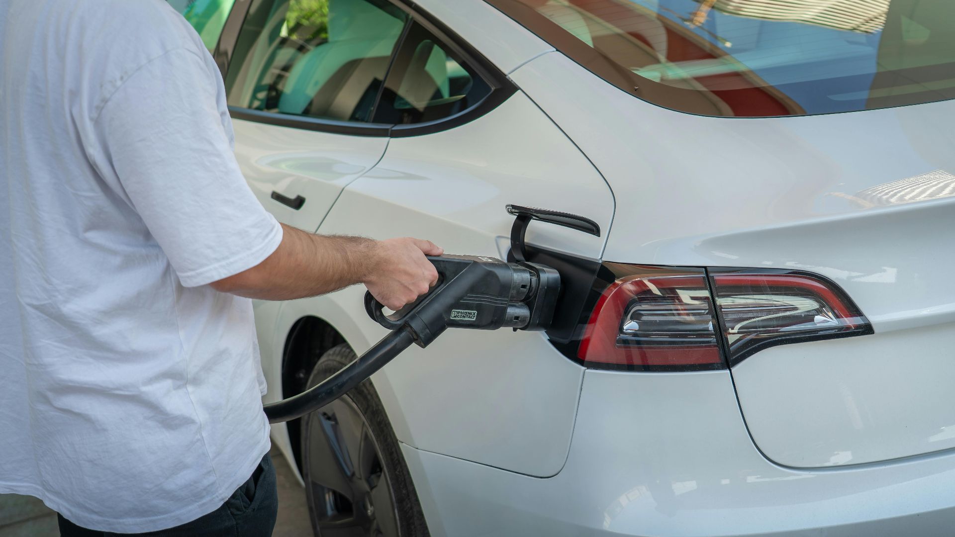 Electric car being charged at a station, highlighting eco-friendly transportation.