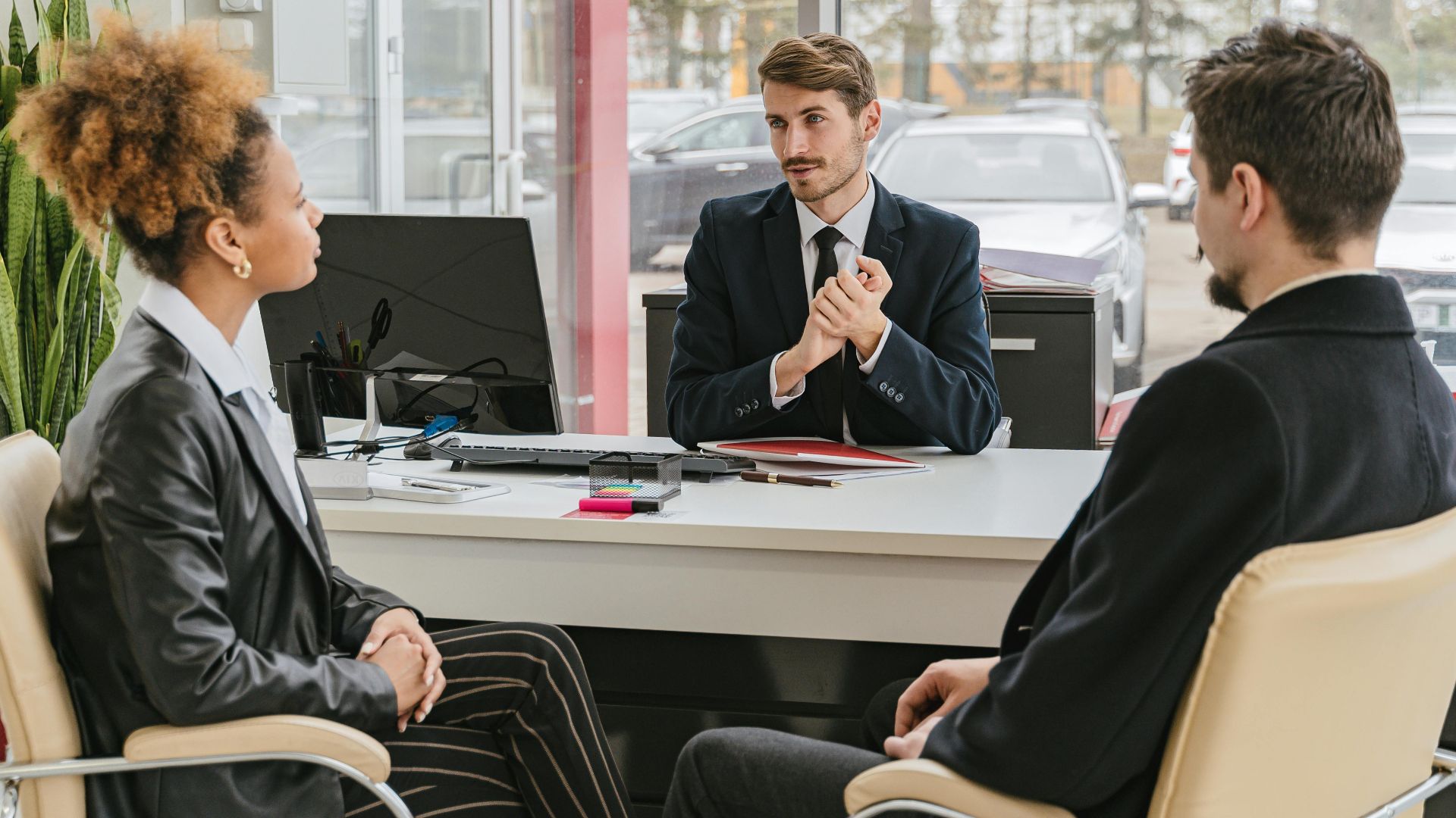 Professional meeting with clients at a modern office, discussing business solutions.