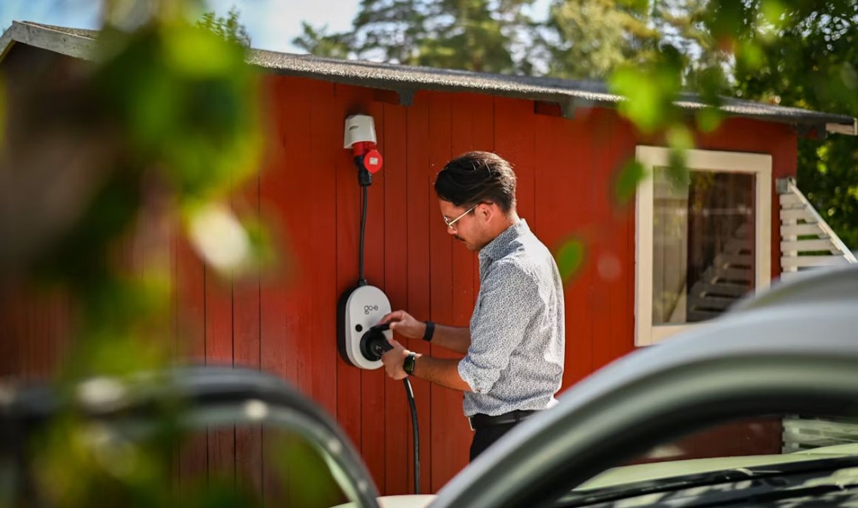 Man plugging in an electric car charger