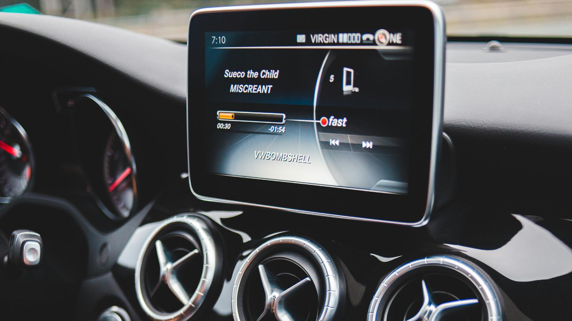Small black touchpad and loud speakers of modern multimedia player in cabin of automobile