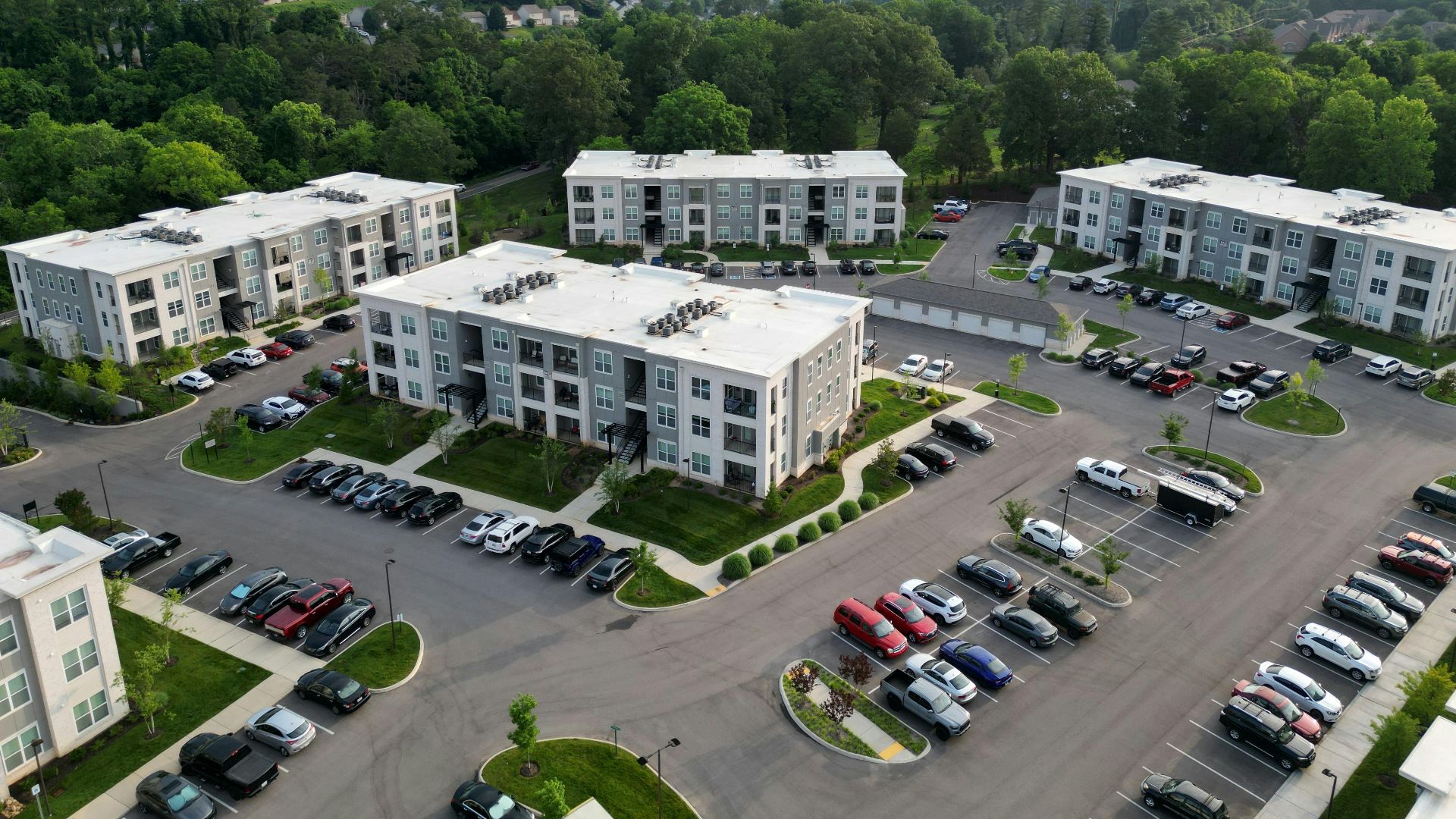 Aerial view of modern apartment complexes with greenery in Knoxville, TN.