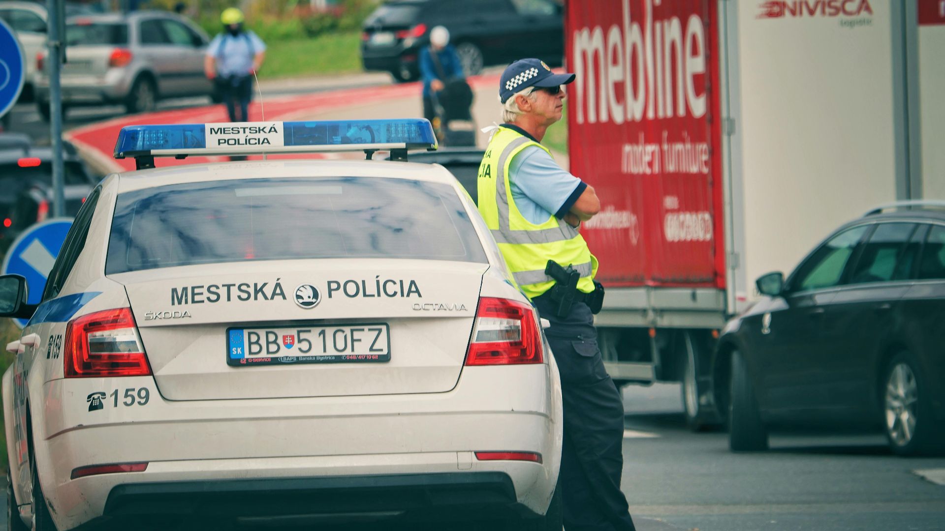 Police officer managing traffic on a city street in Slovakia.