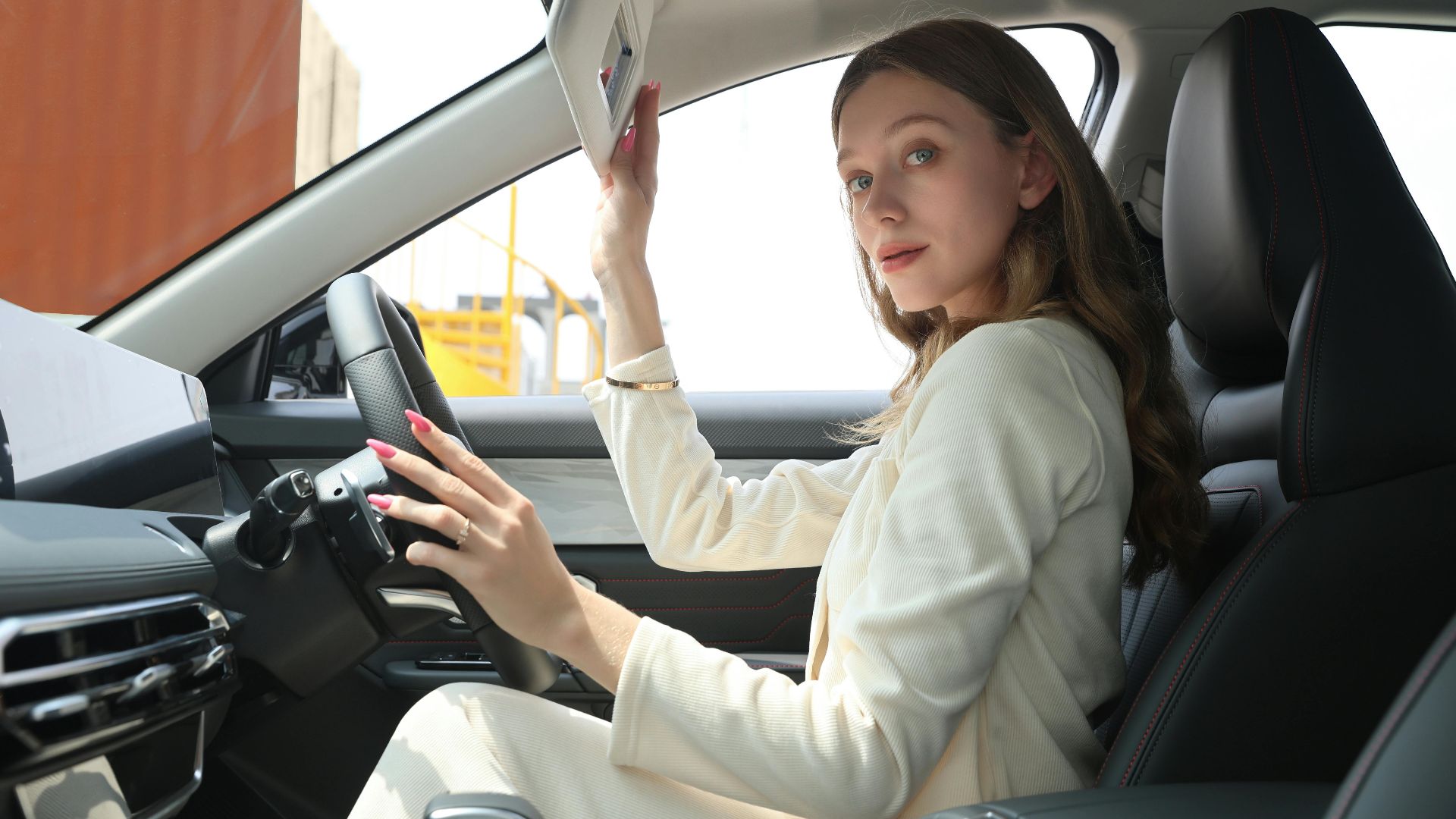 Stylish woman in an elegant car adjusting sun visor, emphasizing premium lifestyle and modern car interior.