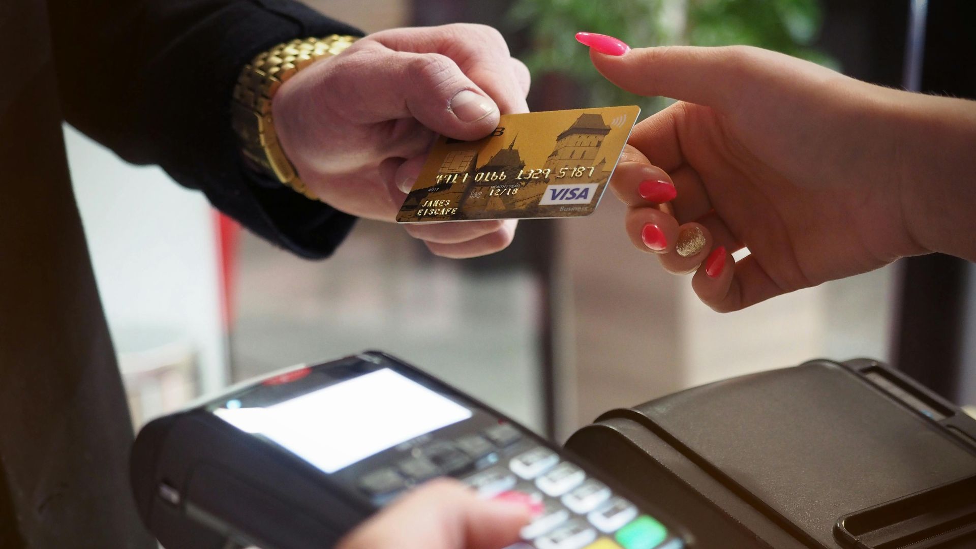 Close-up of a credit card payment being processed at a POS terminal.