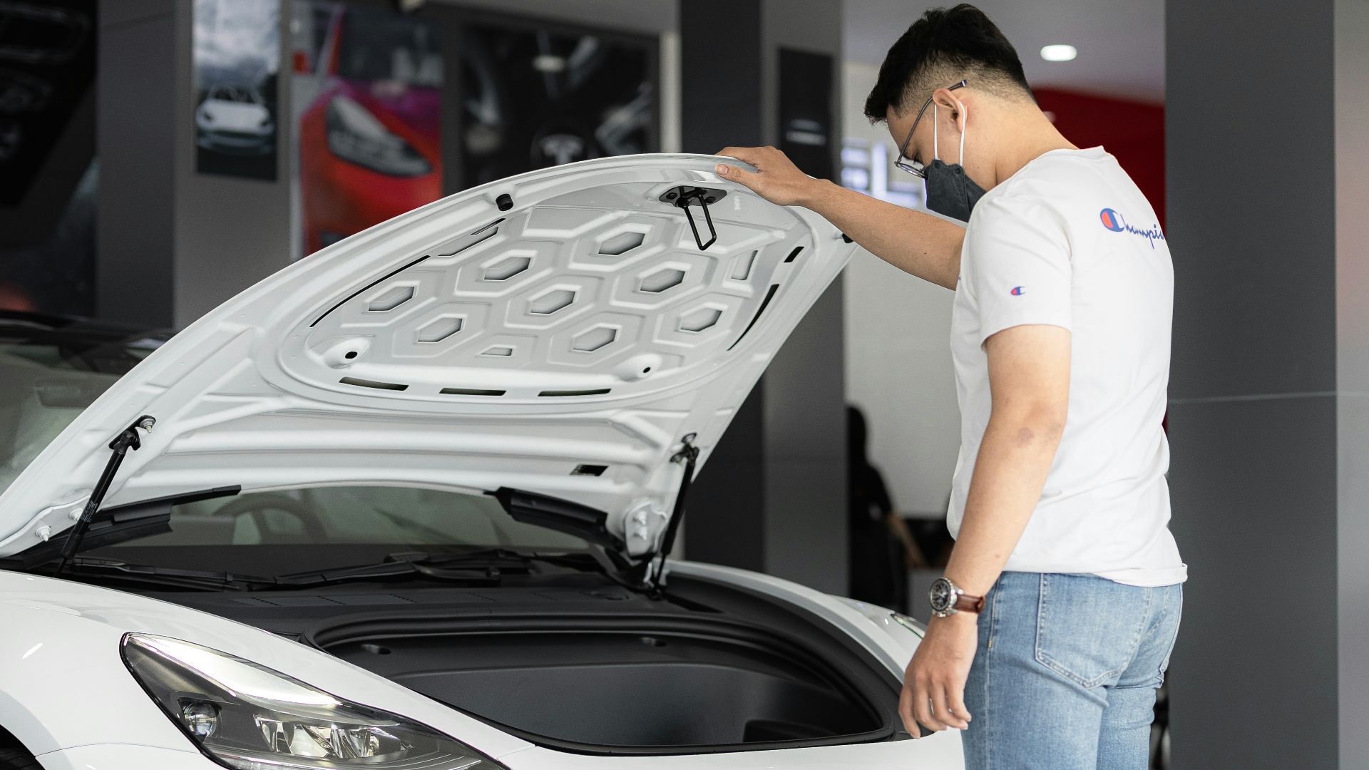 a man looking under the hood of a car