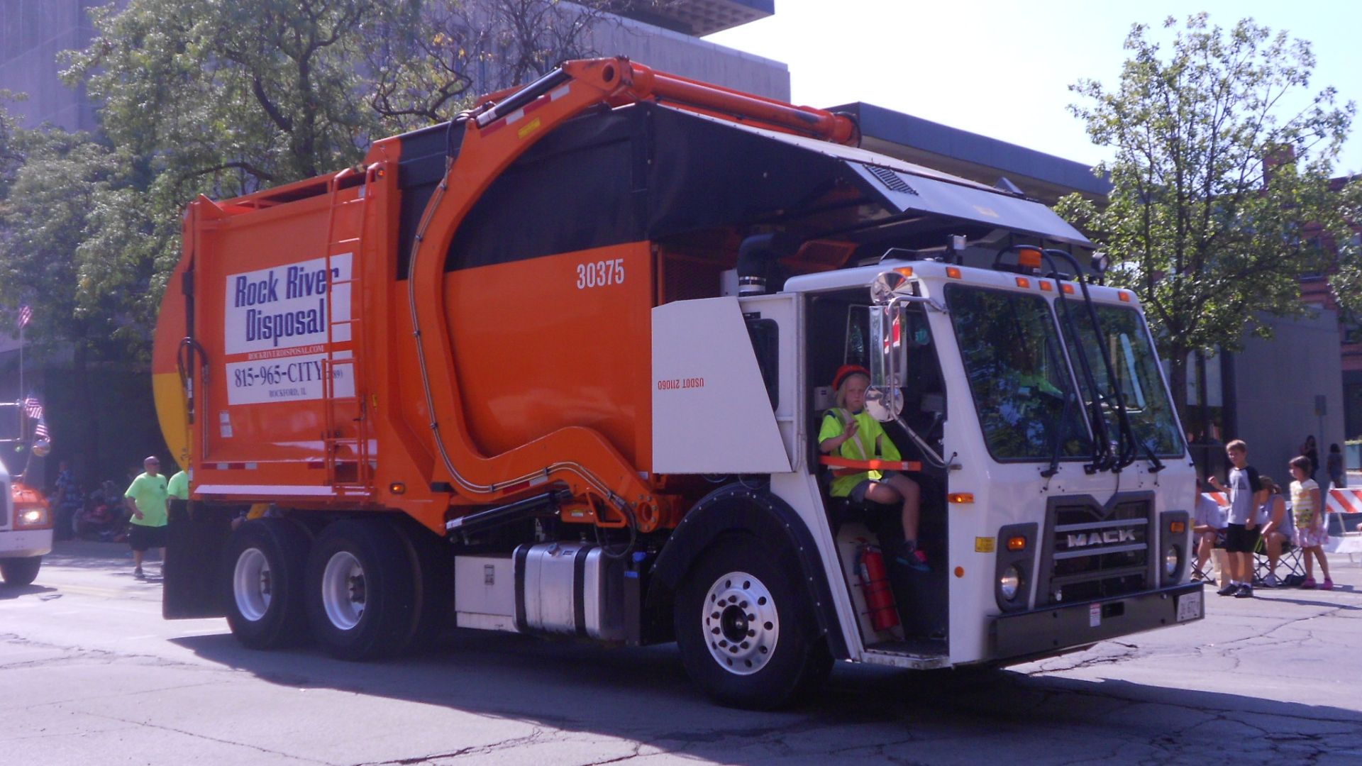 A front 3/4 of a Mack model LR COE refuse truck in Rockford, Illinois.  The truck is photographed in the City Labor Day Parade on September 3, 2012.