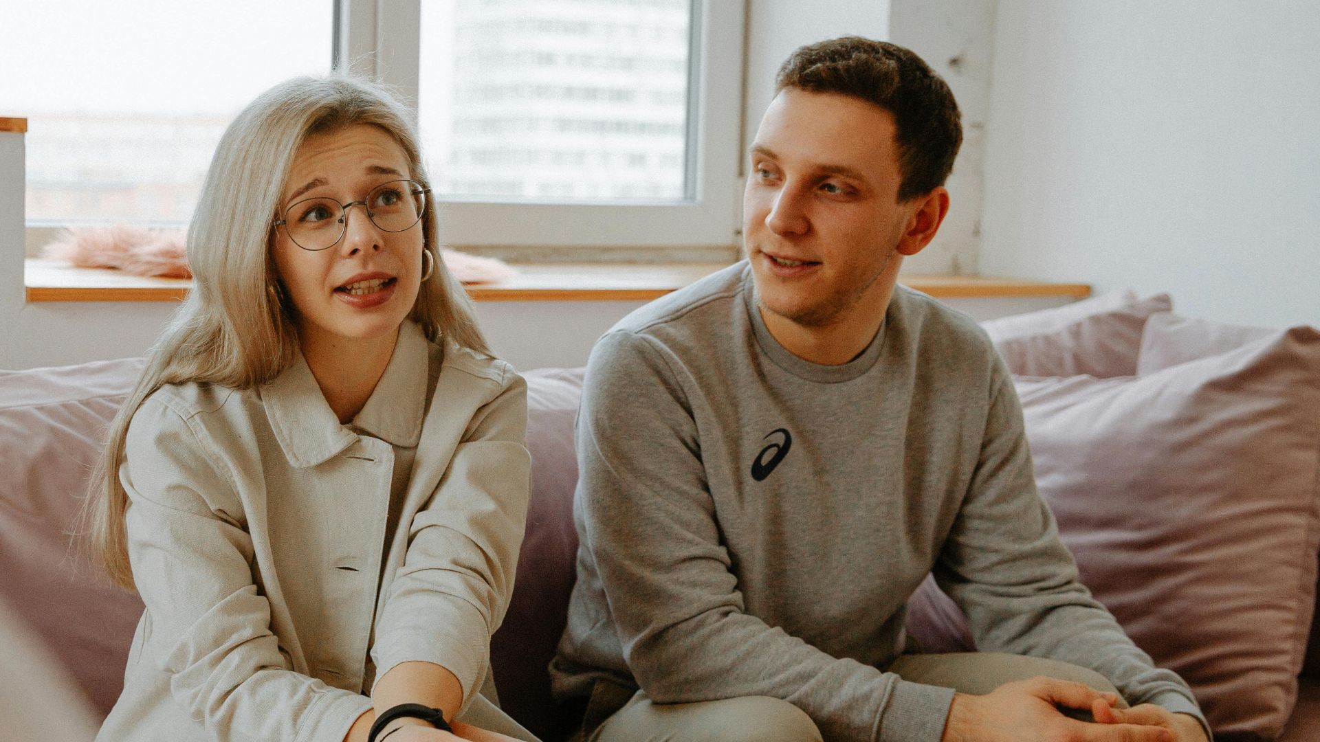 A couple and therapist engaged in a discussion during a therapy session indoors.