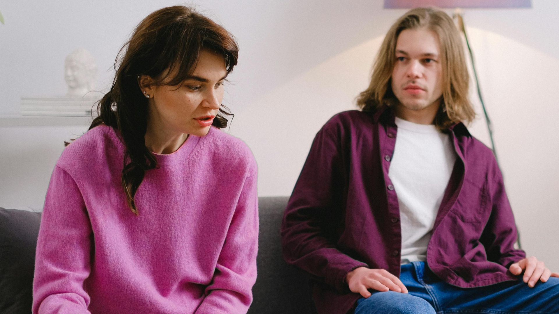 A family participates in a psychotherapy session in a cozy living room setting.