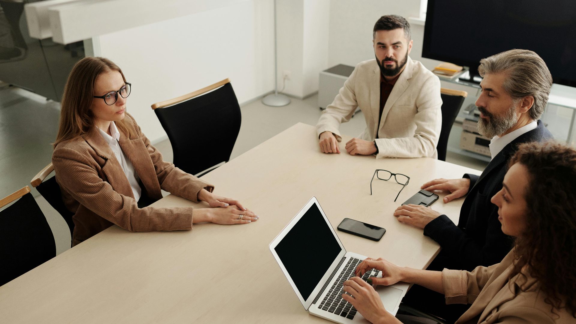 Group of professionals having a business meeting in a modern office setting.