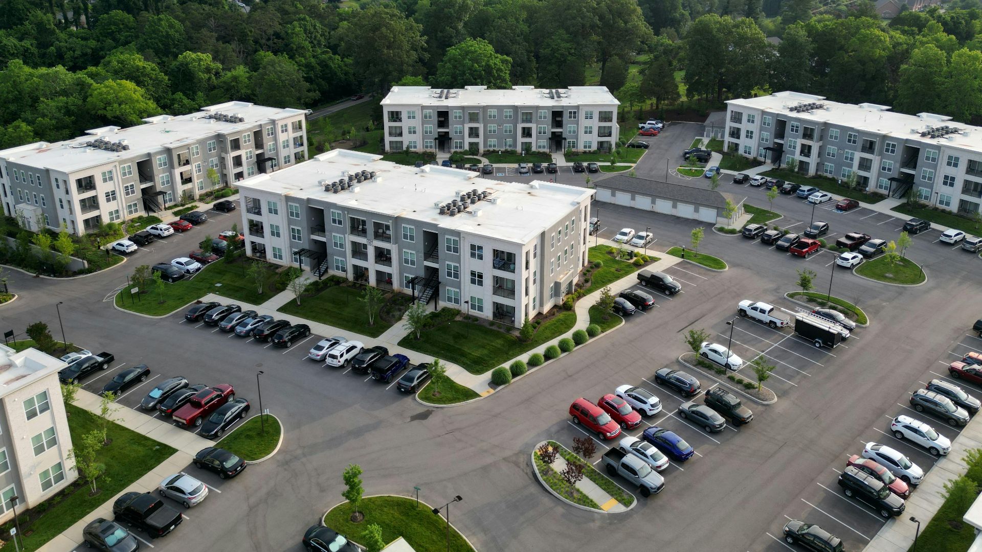 Aerial view of modern apartment complexes with greenery in Knoxville, TN.