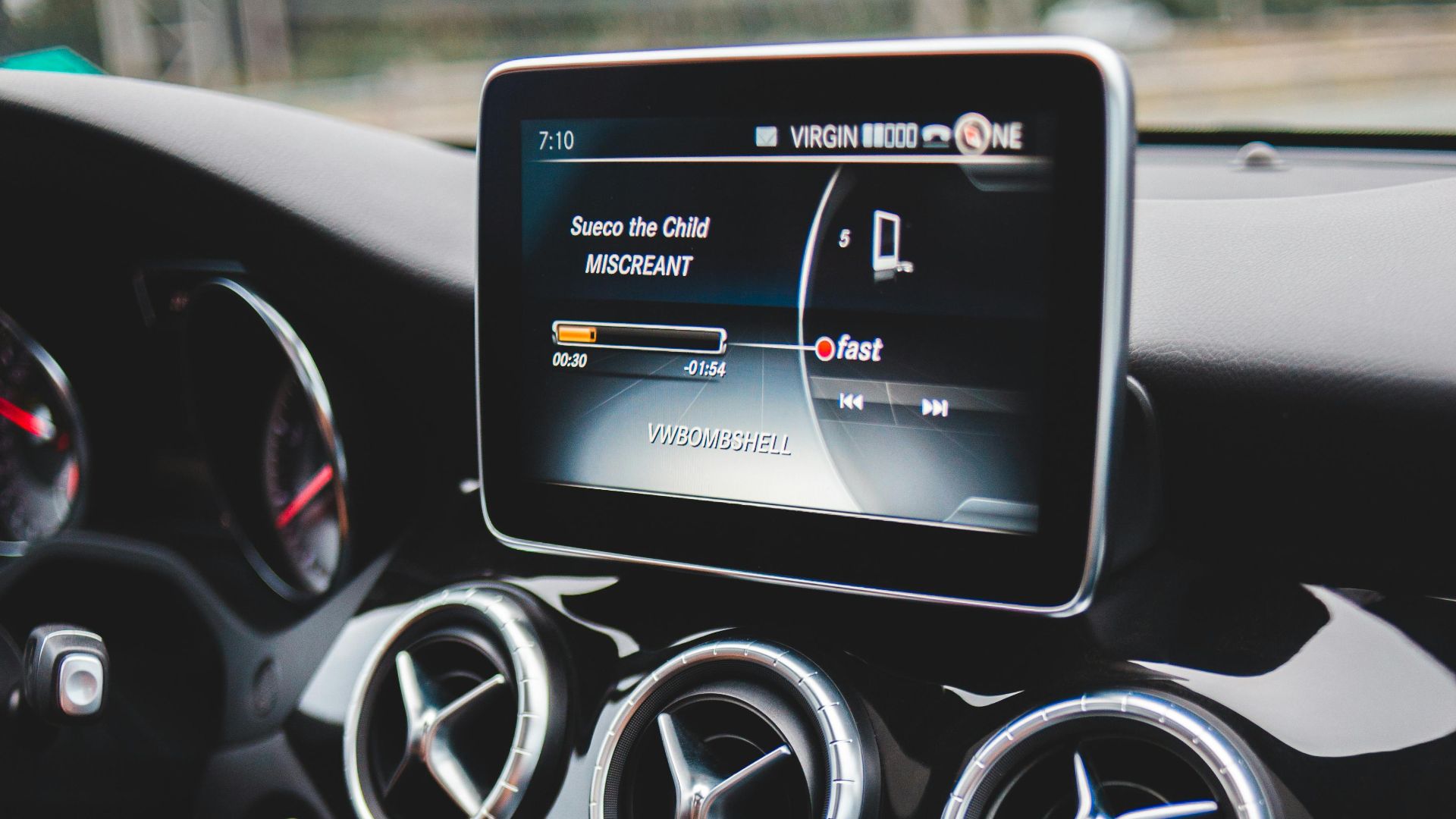 Small black touchpad and loud speakers of modern multimedia player in cabin of automobile