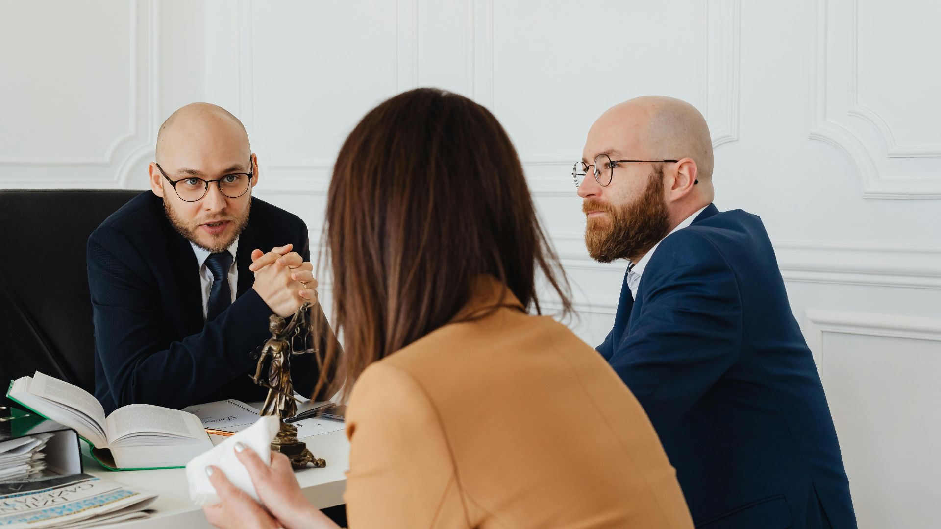 Professional discussion among lawyers in a modern office, focusing on legal matters.