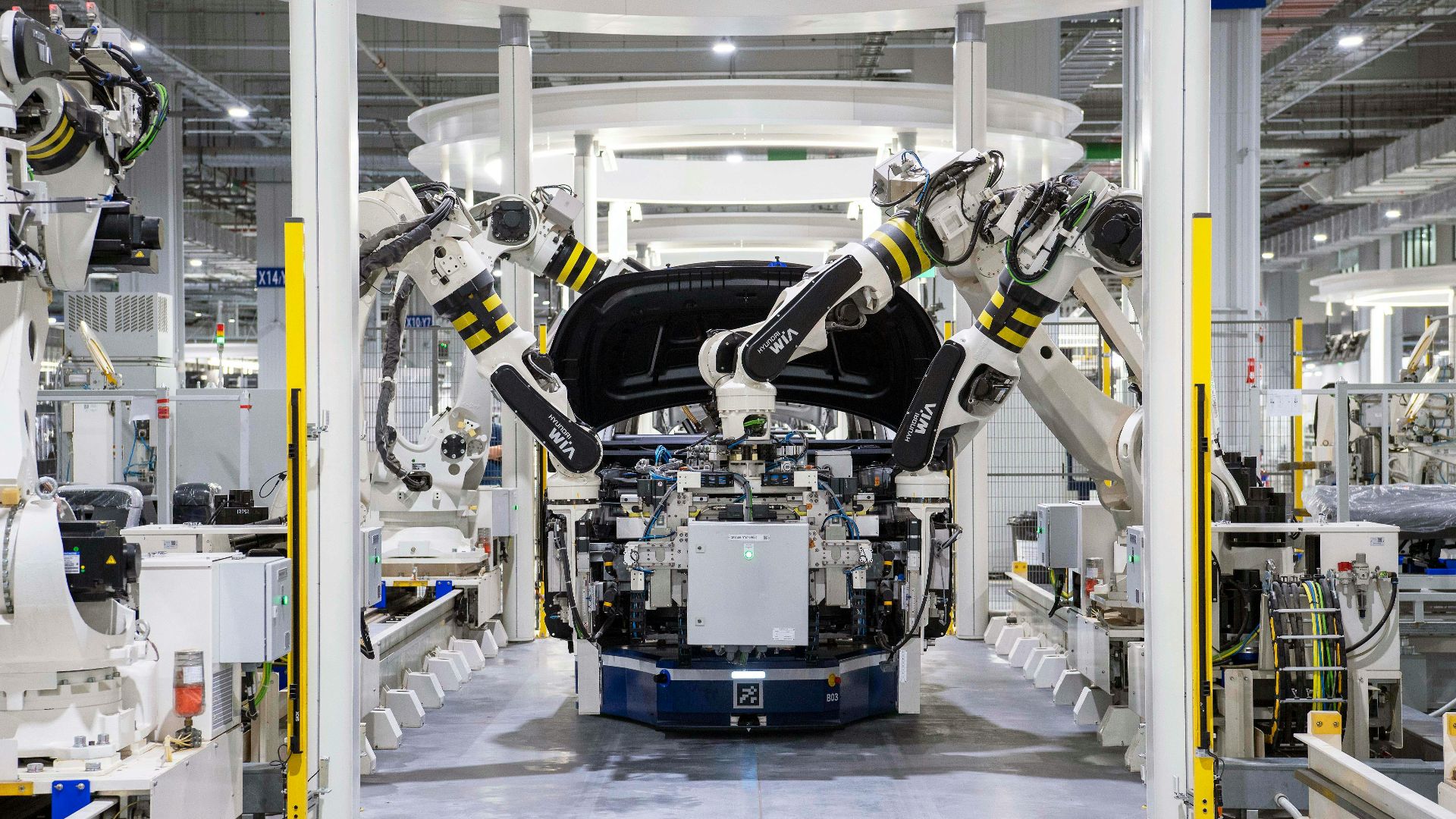 High-tech robots assembling a car in a modern factory setting, showcasing automation.