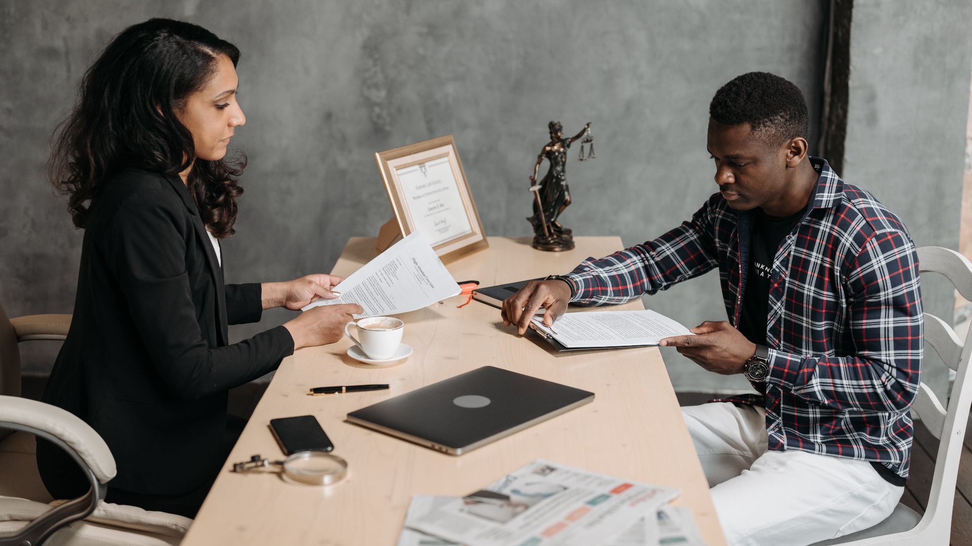 Business professionals discussing documents in a modern office setting.