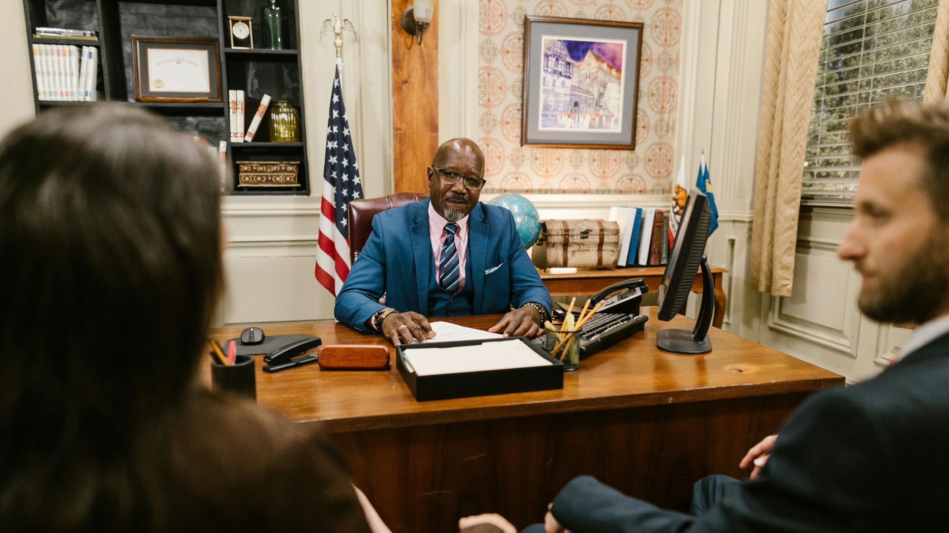 A professional lawyer meeting with clients in his office at a legal consultation.
