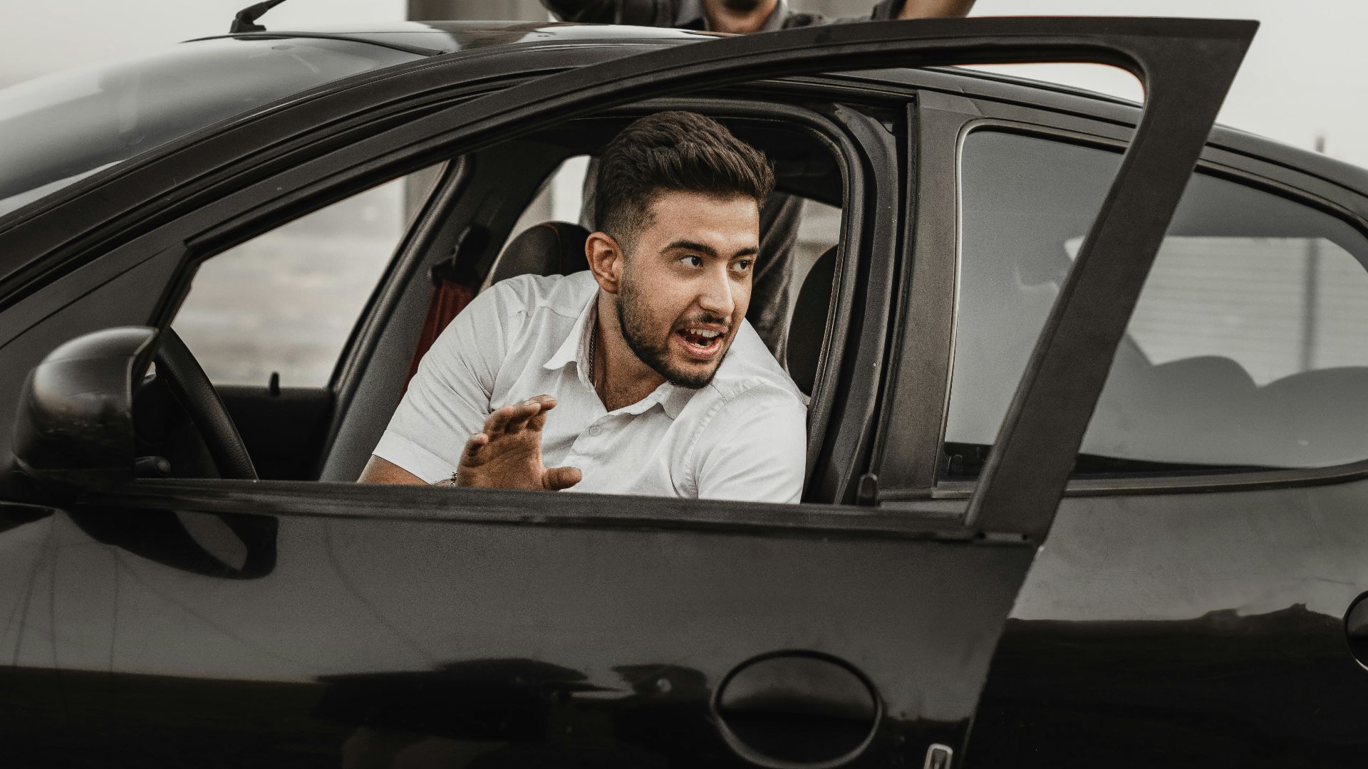 a person sitting on the seat of a car
