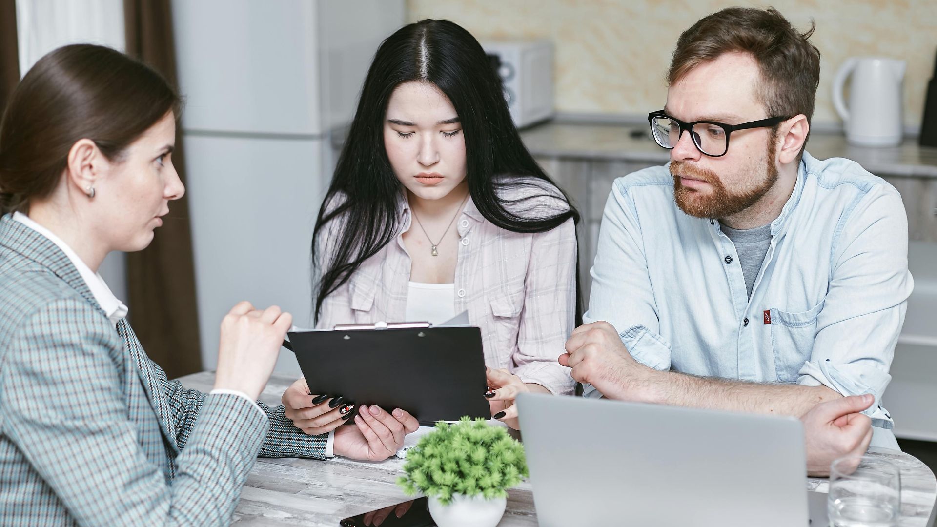 A group of professionals discussing business strategies at a table indoors.