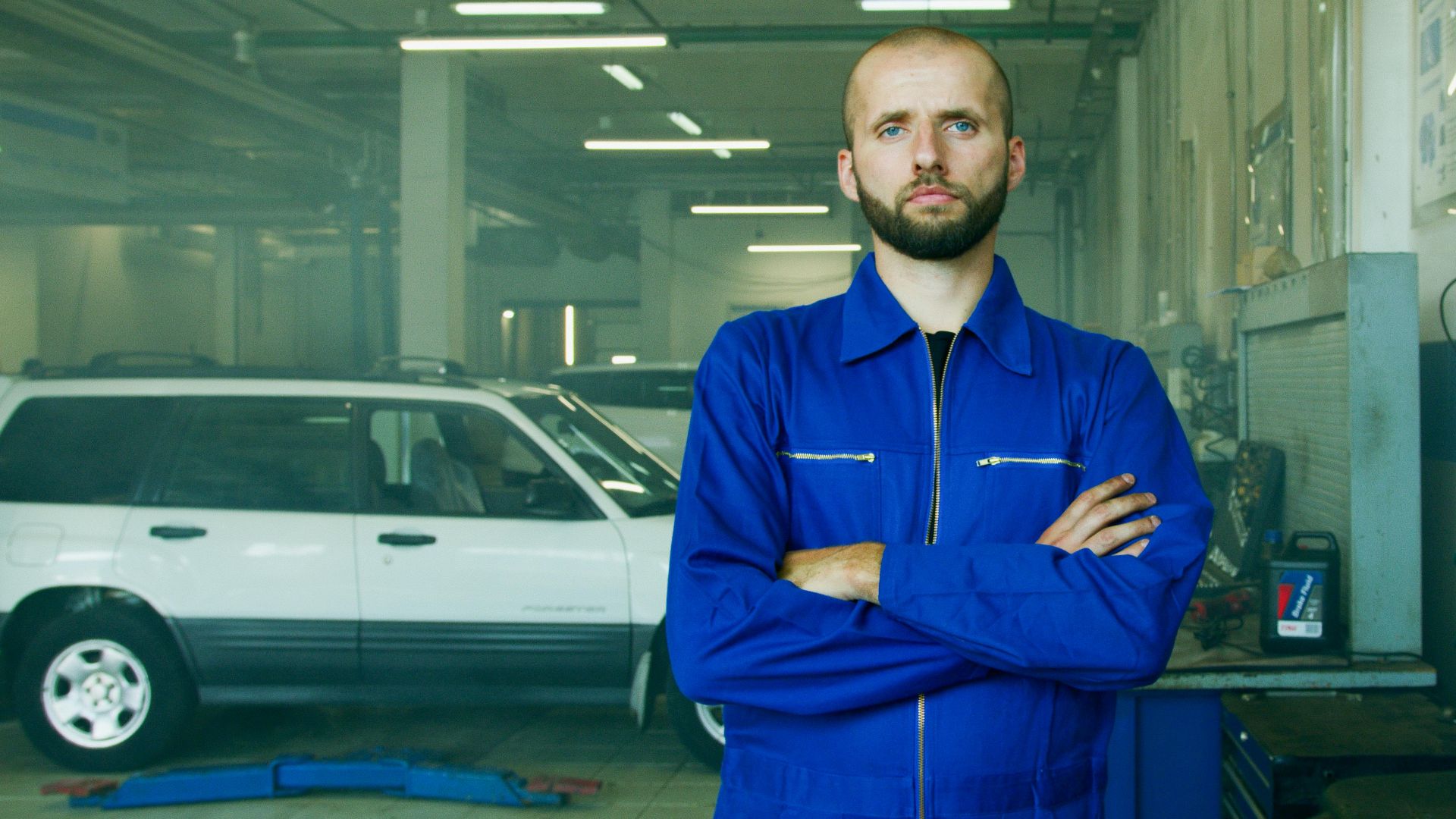 Professional mechanic in a repair shop, focused on car maintenance and vehicle service.