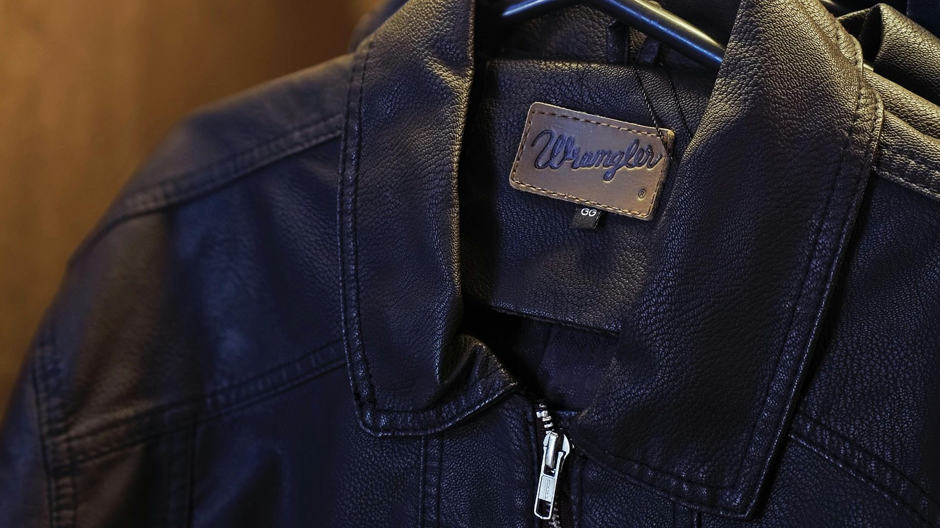 Stylish black leather jackets neatly hung on hangers inside a closet, showcasing fashion detail.
