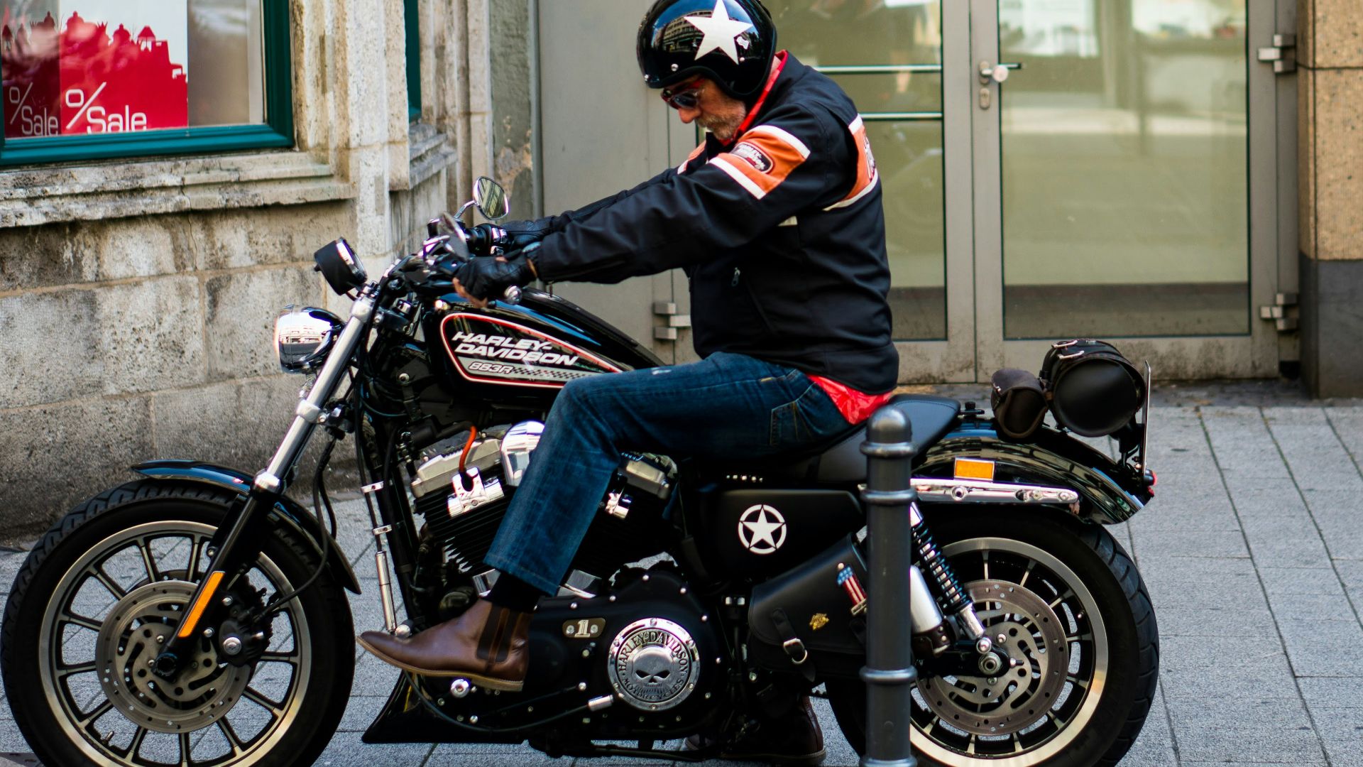 man riding black cruiser motorcycle