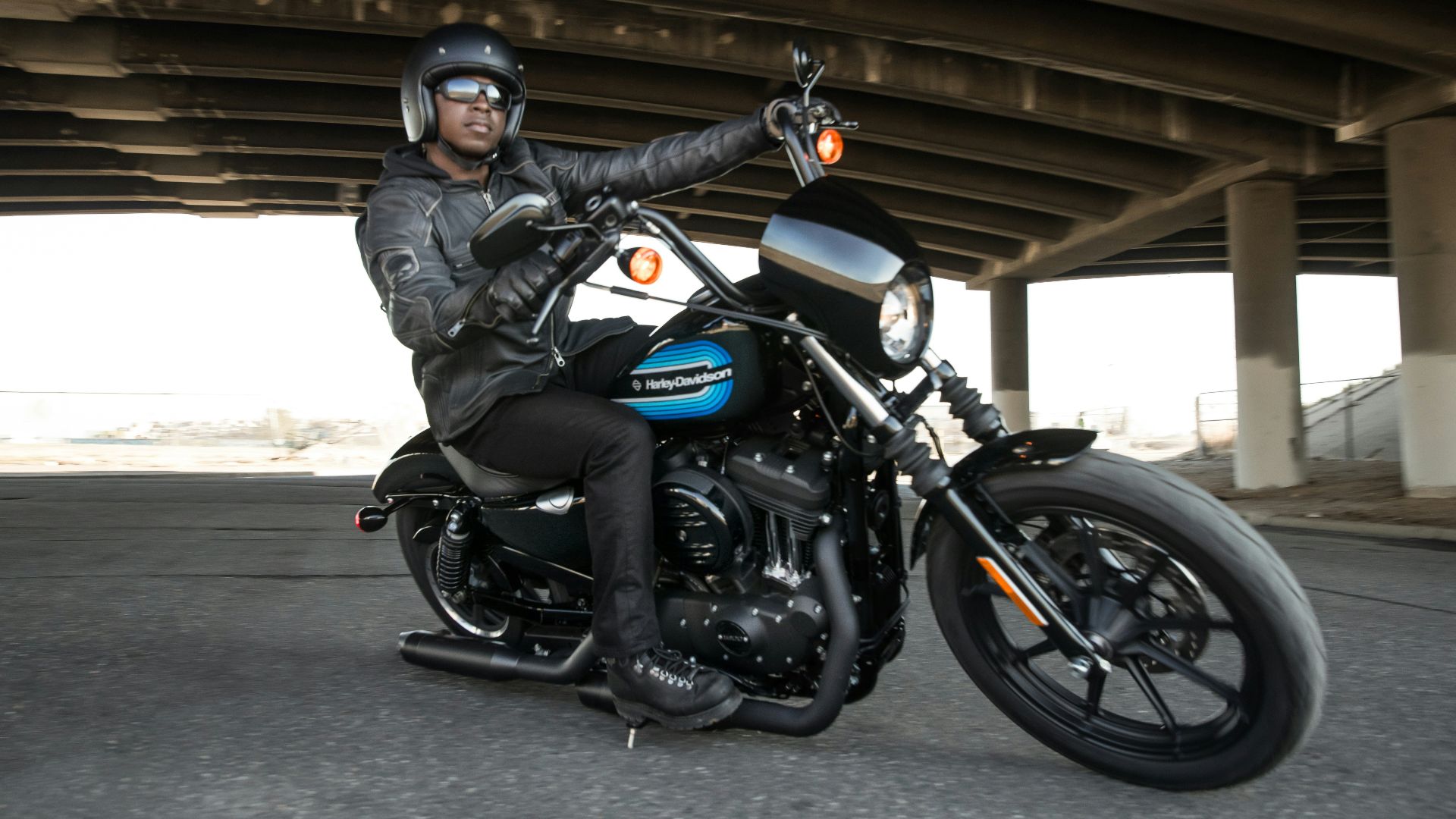man riding black motorcycle