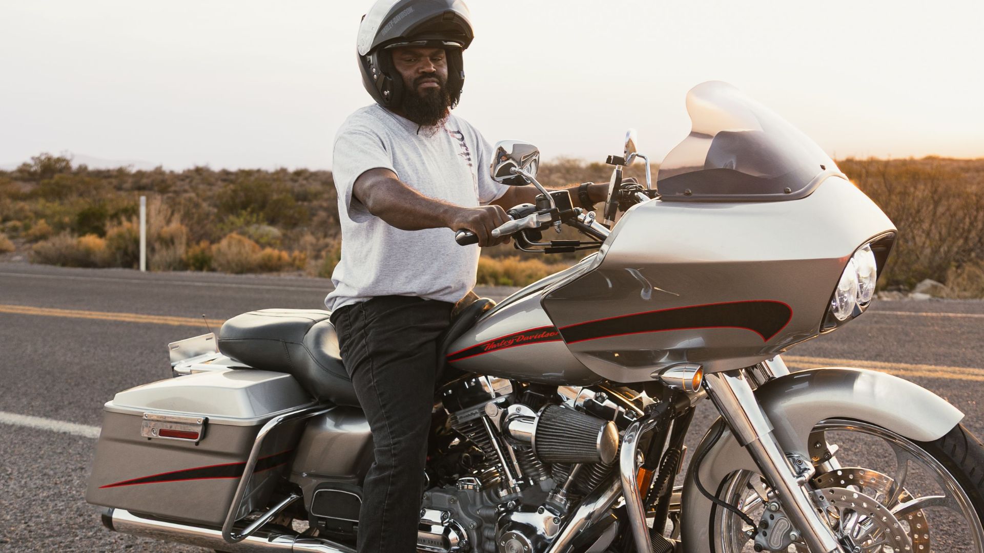 Biker on a Harley-Davidson enjoying a sunset ride on Route 66 in New Mexico.