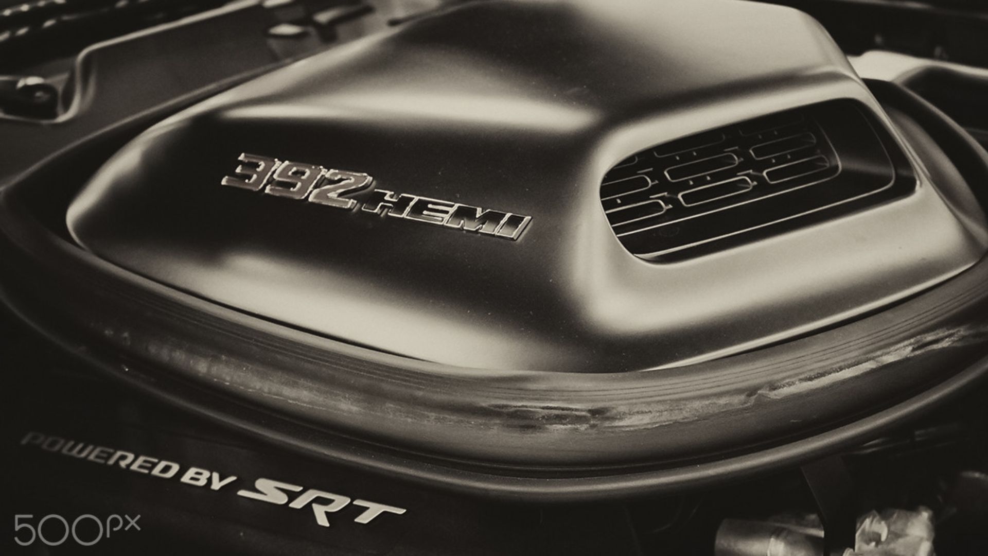 500px provided description: Because HEMI ! ! 
The 6.4L SRT392 HEMI engine on the Dodge Challenger

Clicked this one at the autoshow in Dallas [#car ,#cars ,#warm ,#black ,#sepia ,#canon ,#racing ,#rebel ,#america ,#power ,#american ,#coupe ,#chrysler ,#burnout ,#drag ,#500d ,#muscle car ,#dodge ,#challenger ,#srt ,#t1i ,#dodge challenger ,#v8 ,#musclecar ,#torque ,#kit lens ,#hemi ,#FCA ,#srt392]