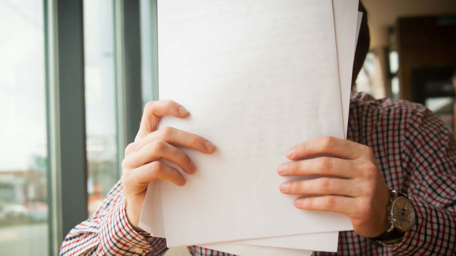 person holding white printer paper