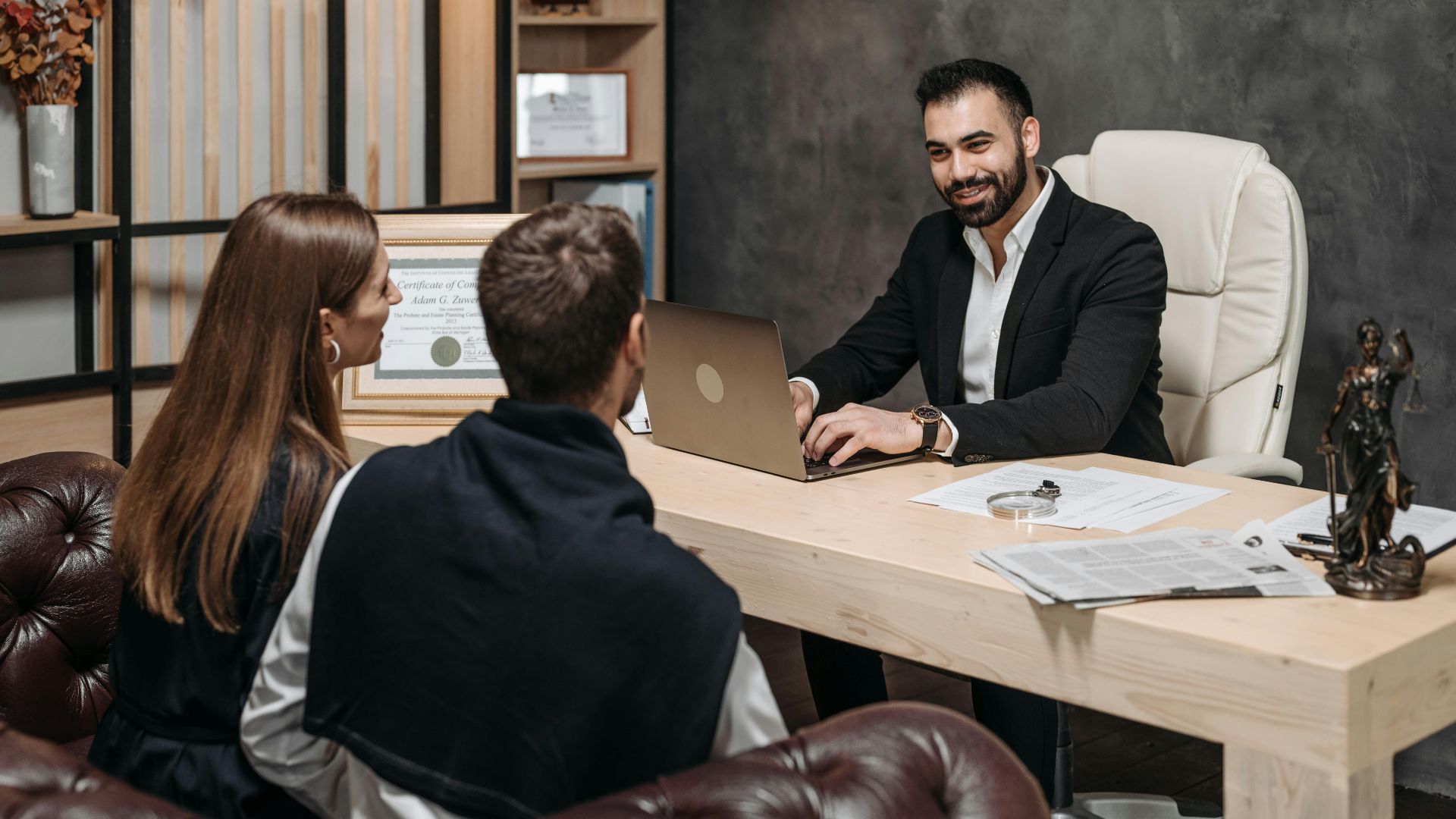 A professional meeting with a lawyer consulting clients in an upscale office environment.