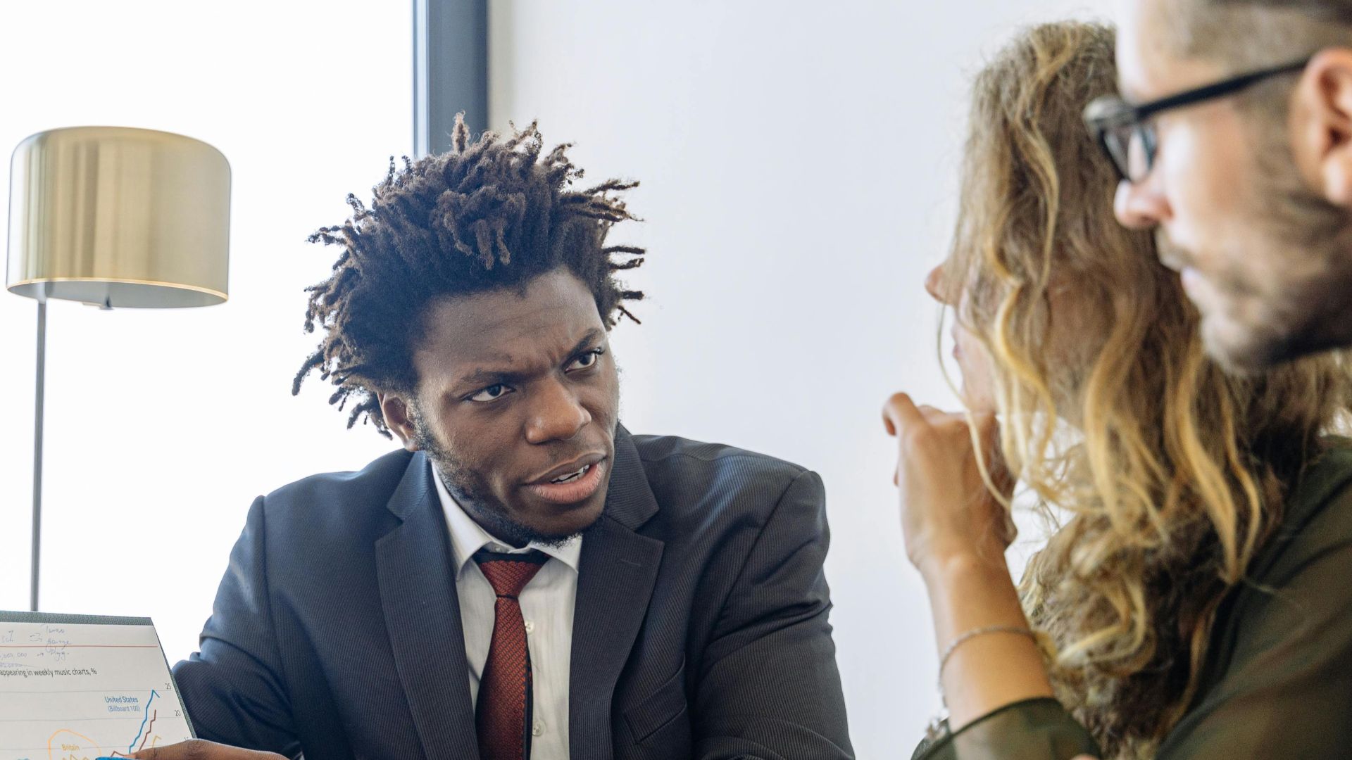Business professionals discussing financial data during a collaborative meeting.