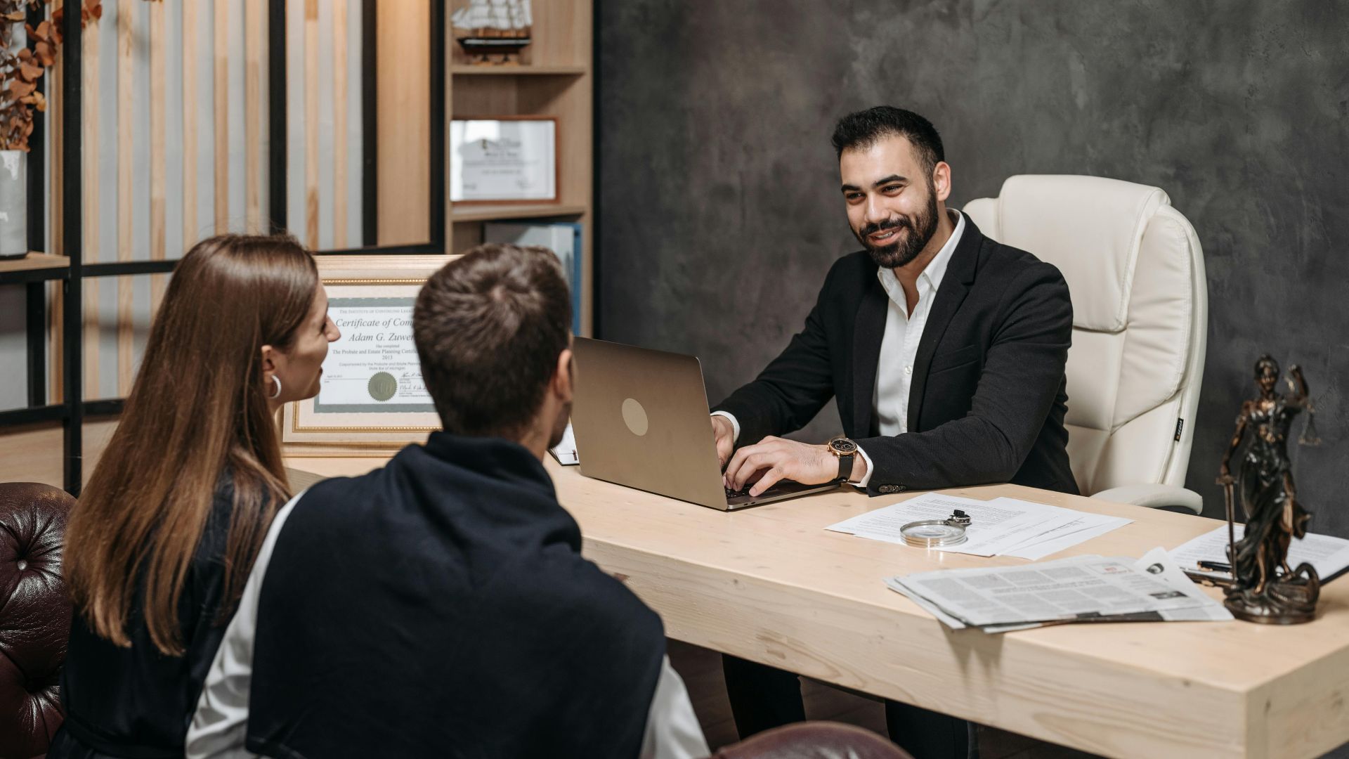 A professional meeting with a lawyer consulting clients in an upscale office environment.