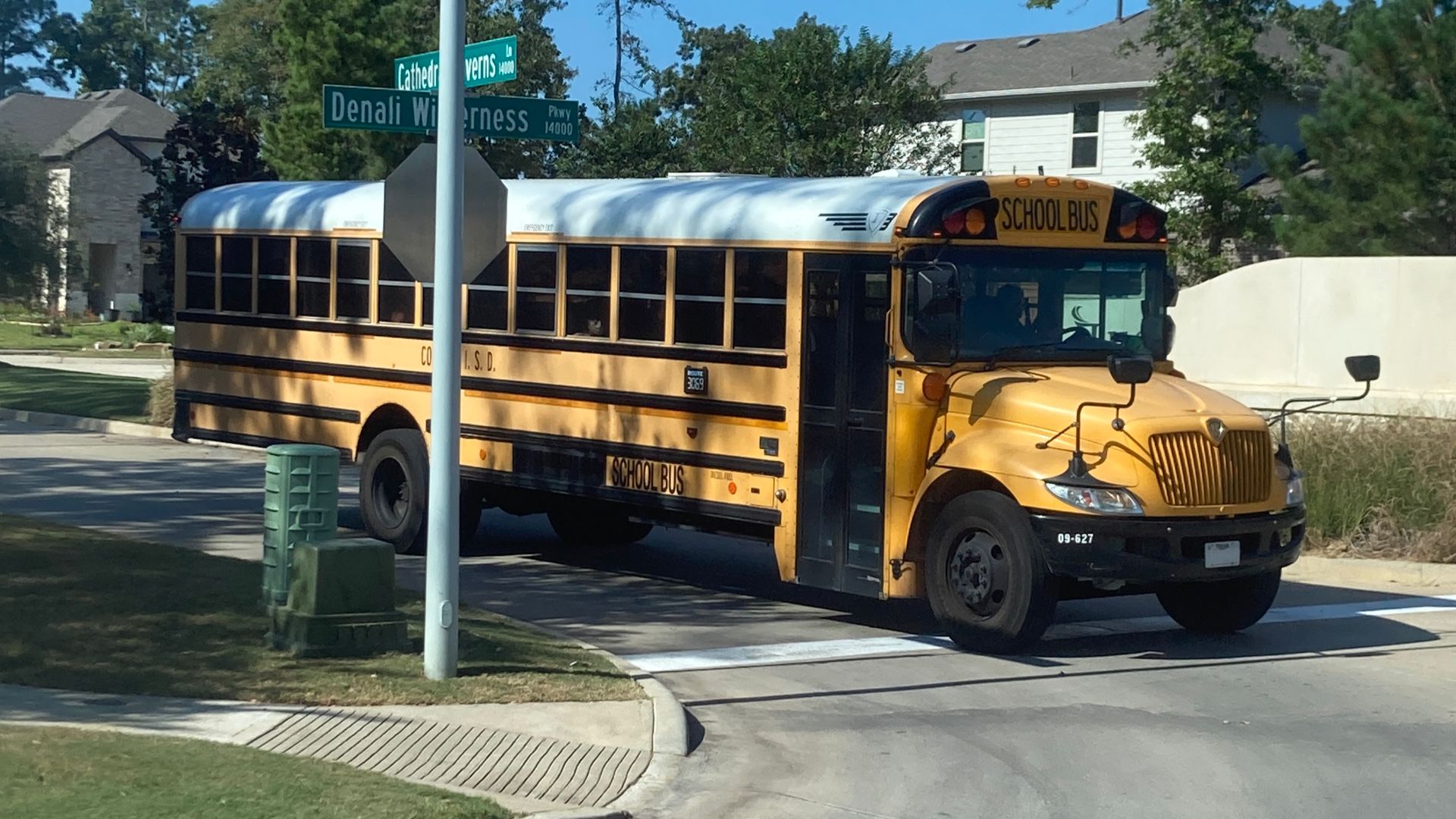 A photograph of a 2009 IC CE 300 yellow school bus, in use by the Conroe Independent School District of Conroe, TX. 
Original photo taken on 10/27/2022. This photo has been retouched and edited.