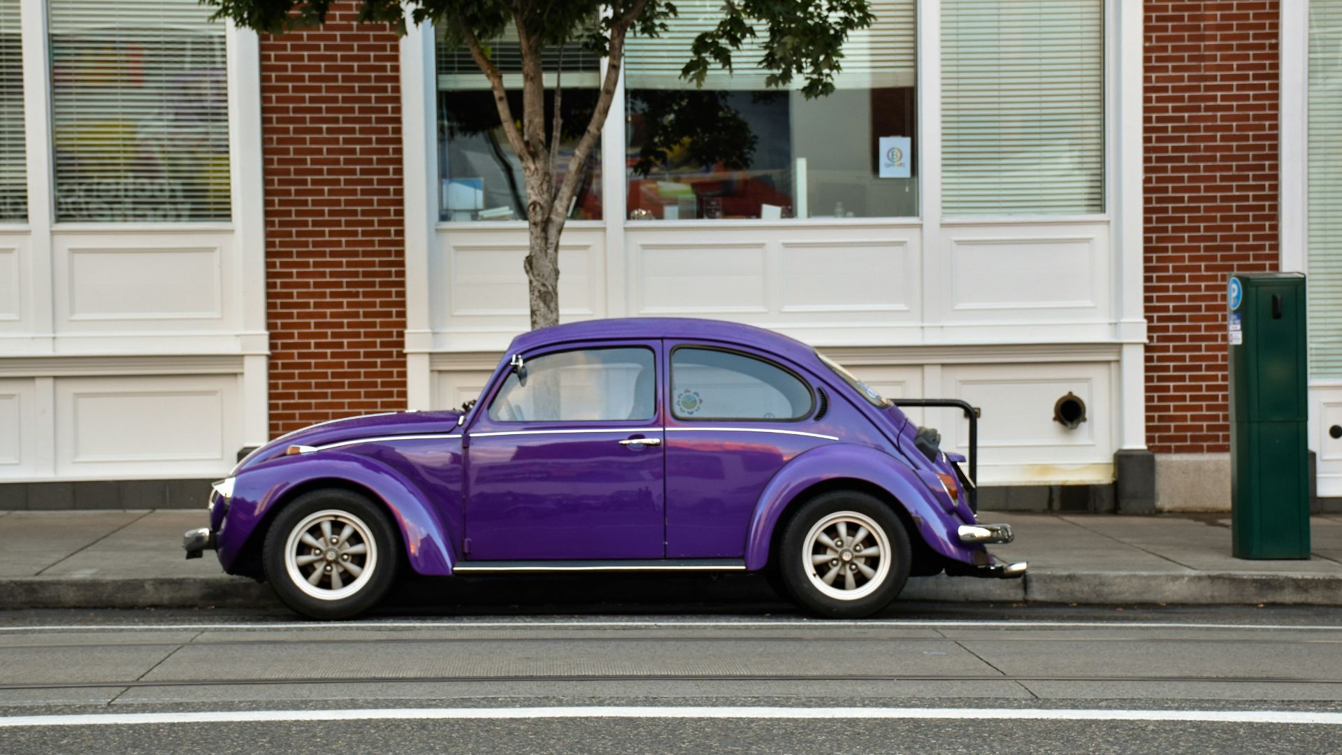 purple 3-door hatchback parked on street