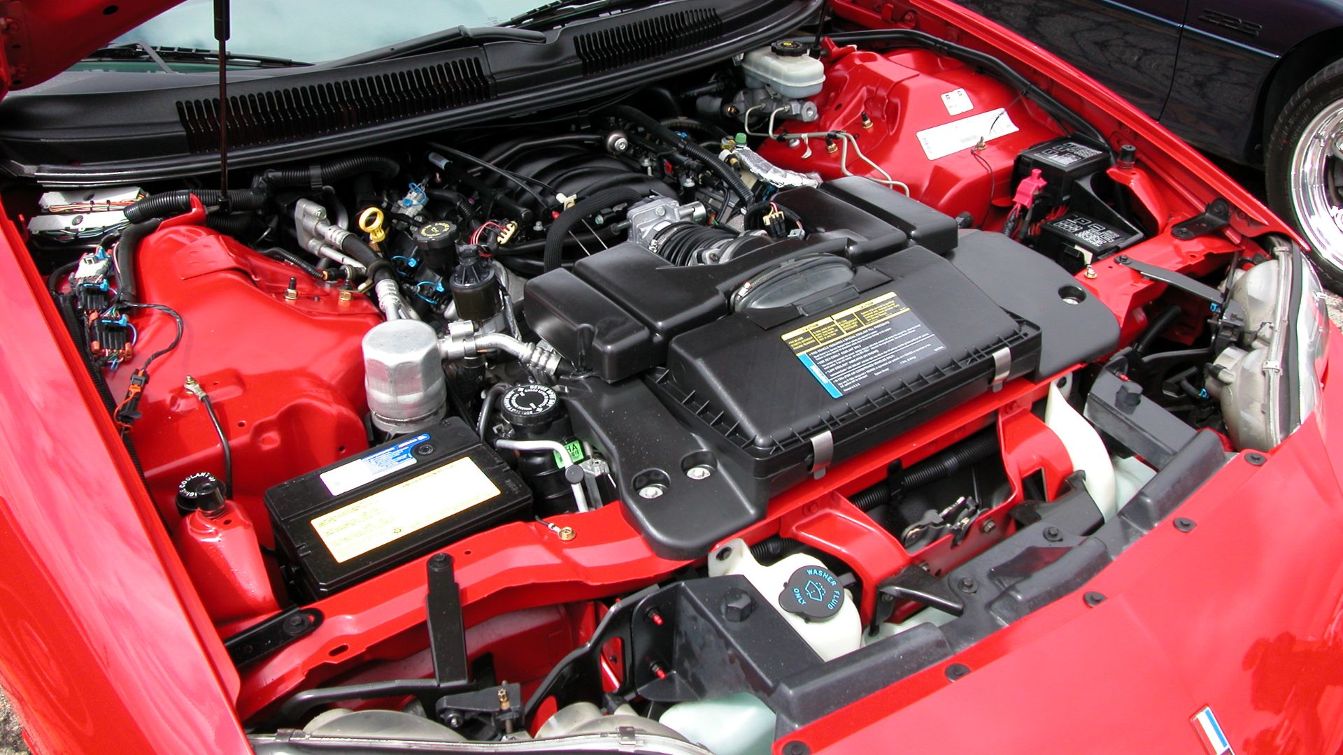This is an image of GM's stock 5.7L LS1 V8 engine that outputs 305hp. This is from my 1998 Chevrolet Camaro Z28 and was taken during the 2003 Super Chevy Show in Pomona, CA. The camera used is a Nikon Coolpix 5000.