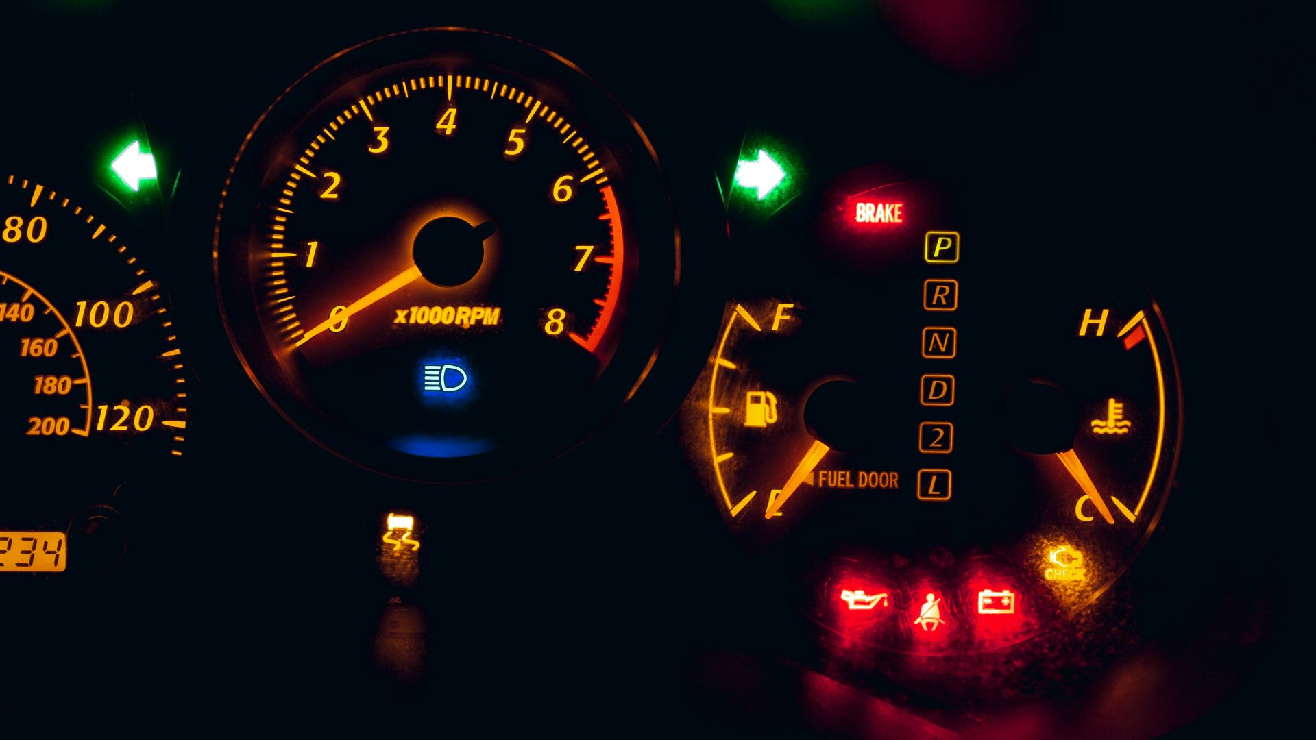 black and yellow analog speedometer