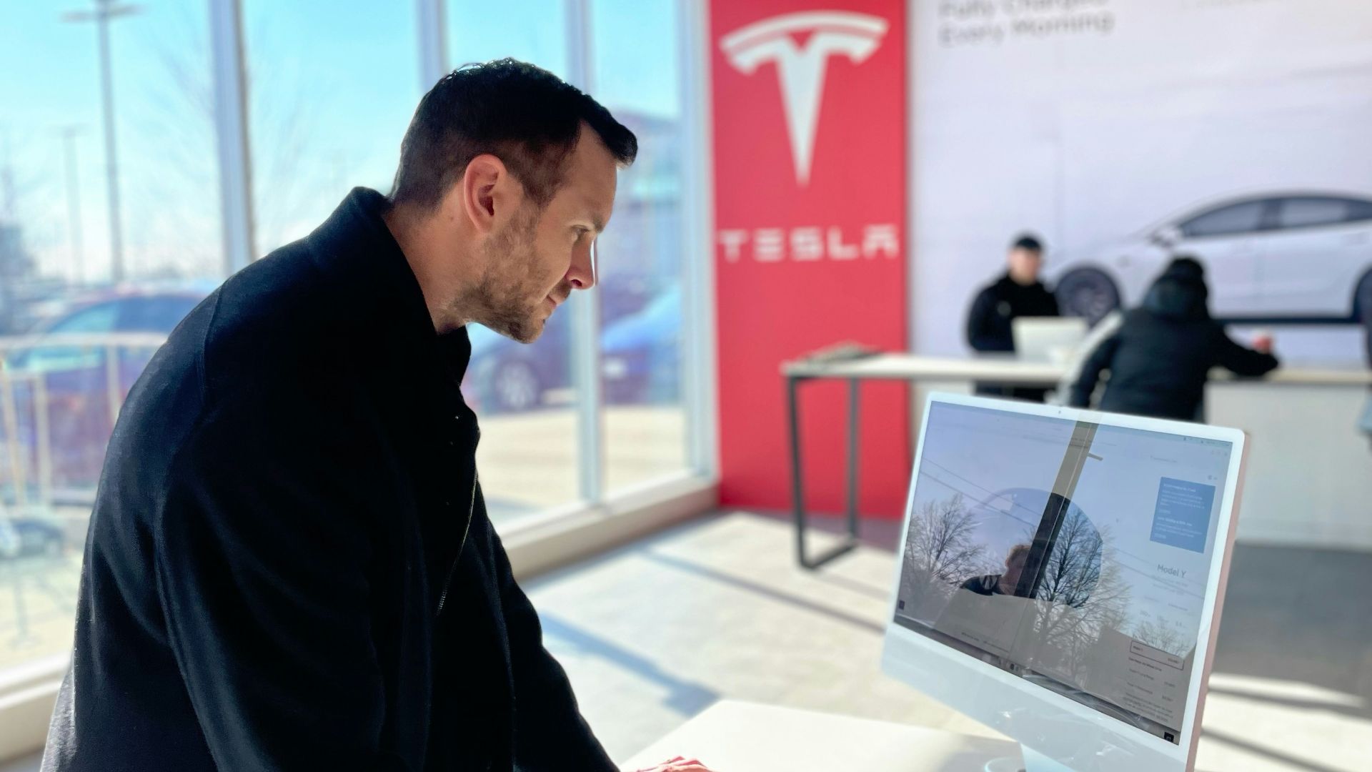 a man sitting at a desk in front of a computer