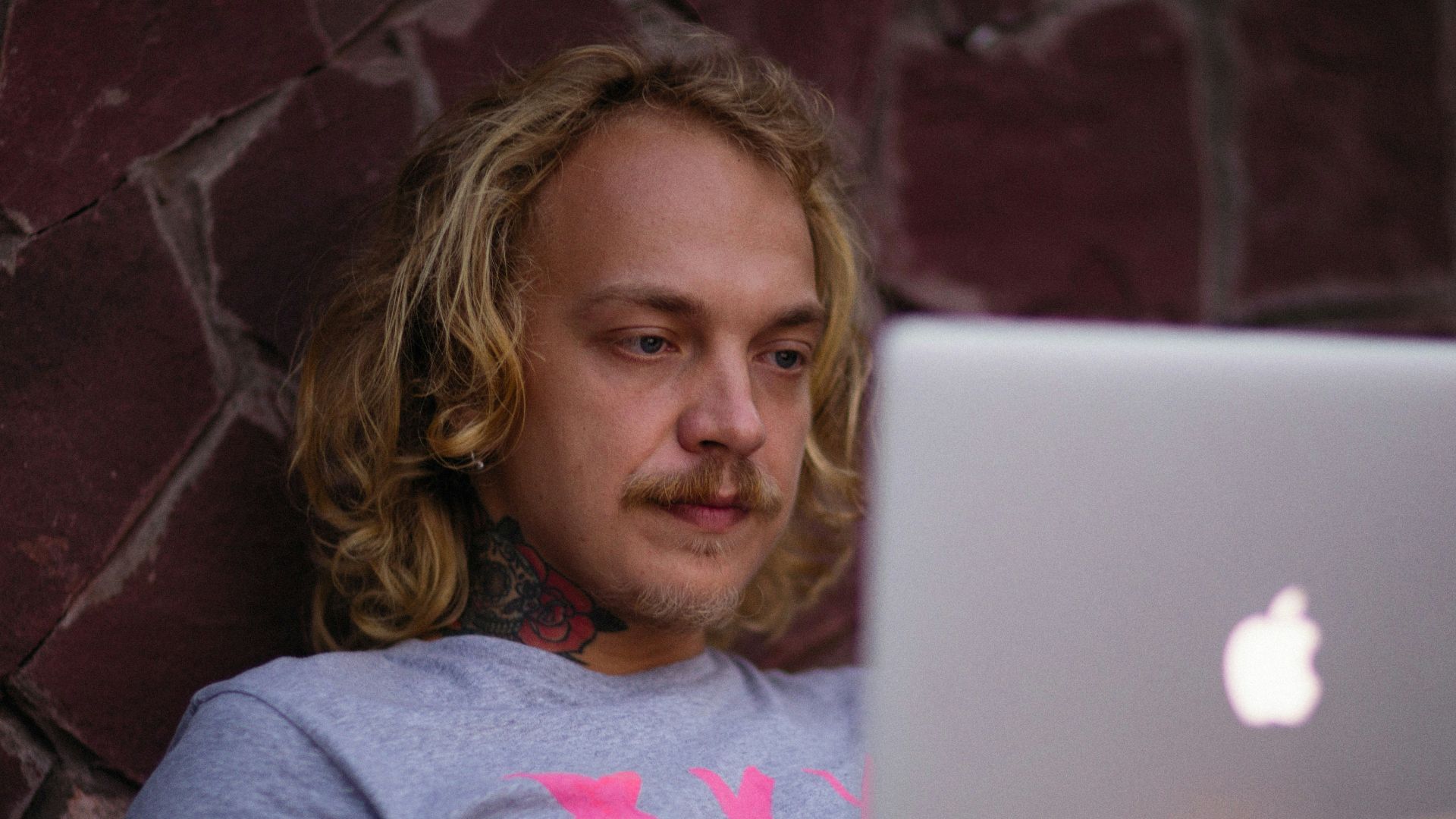 a person sitting on a couch with a laptop
