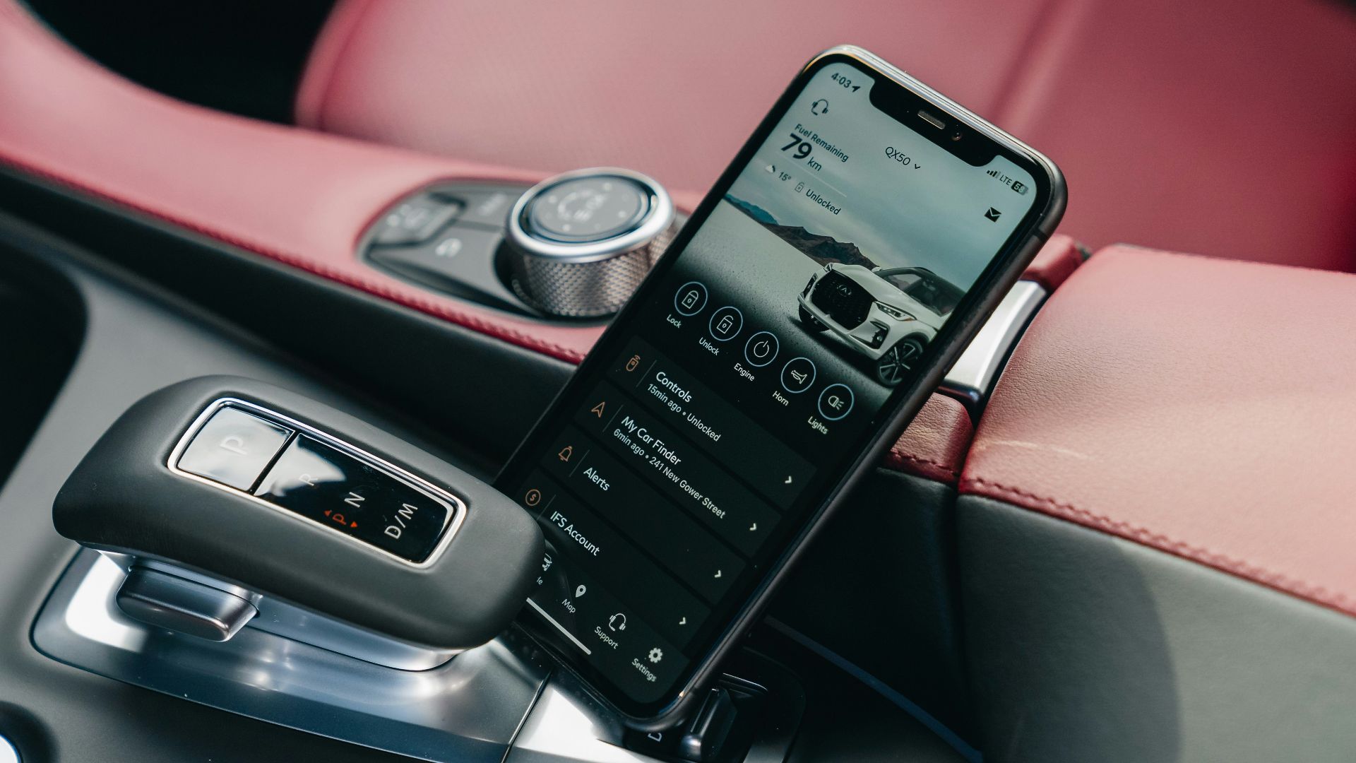 Smartphone displaying car interface in car console.