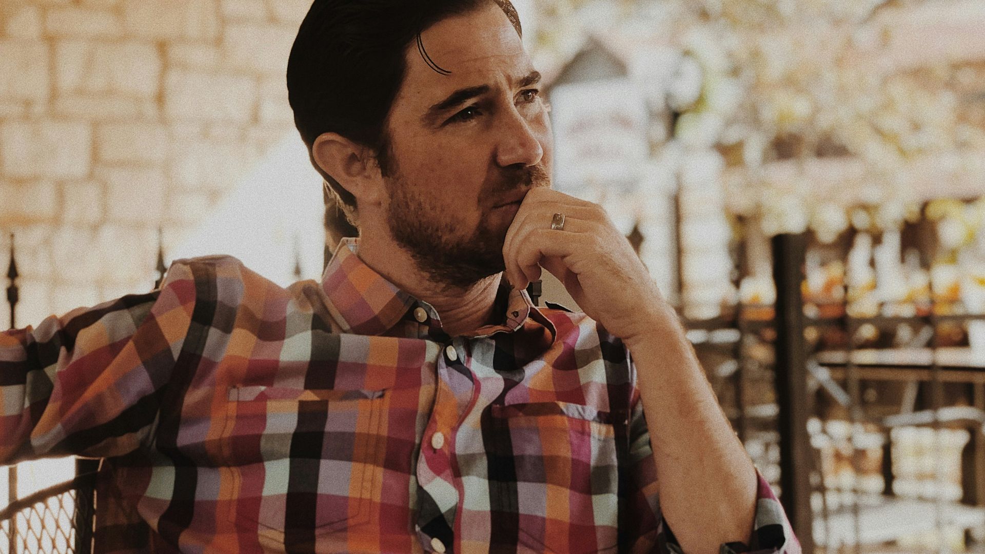 man in red and black plaid dress shirt